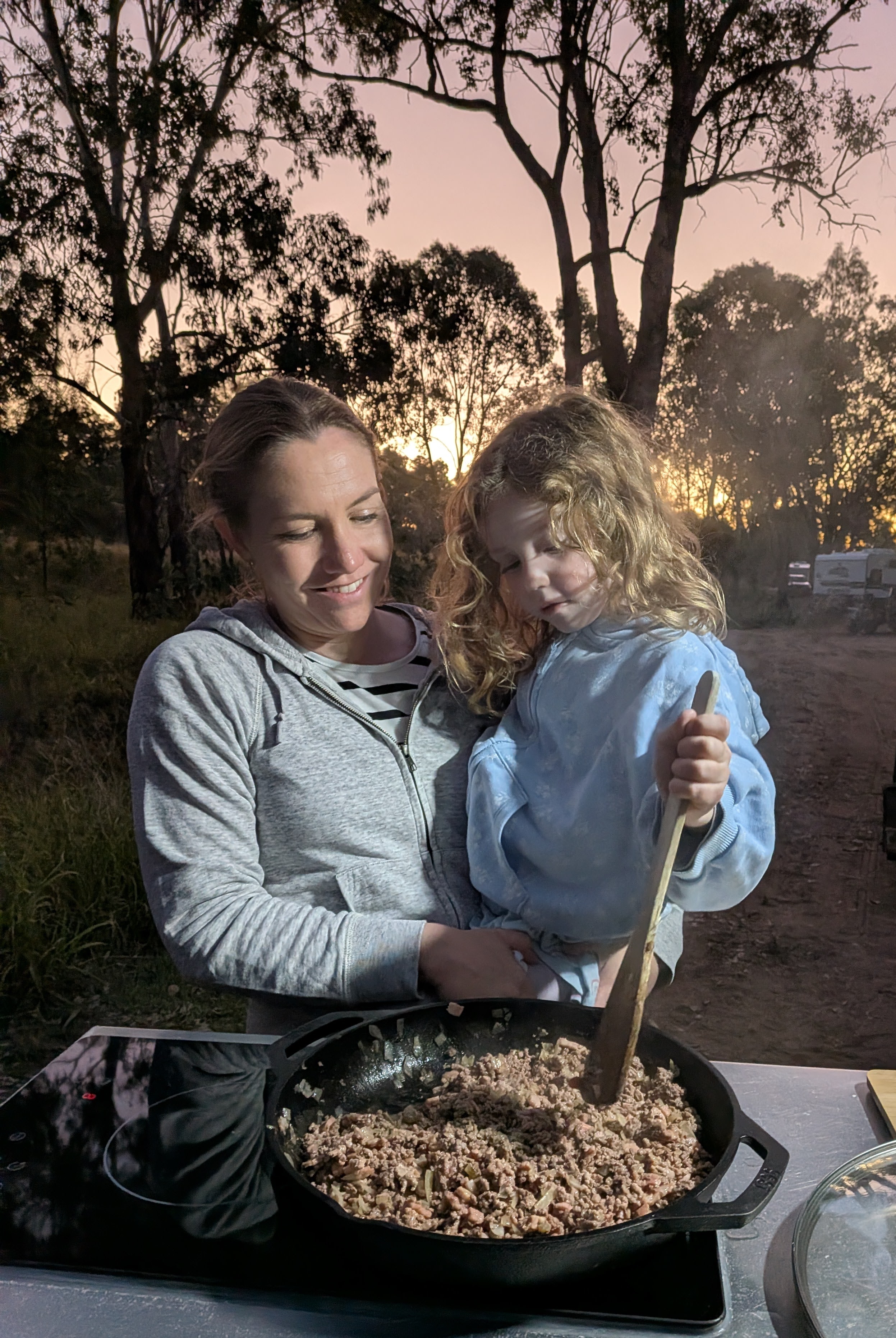 Erin and Leah cooking dinner at sunset