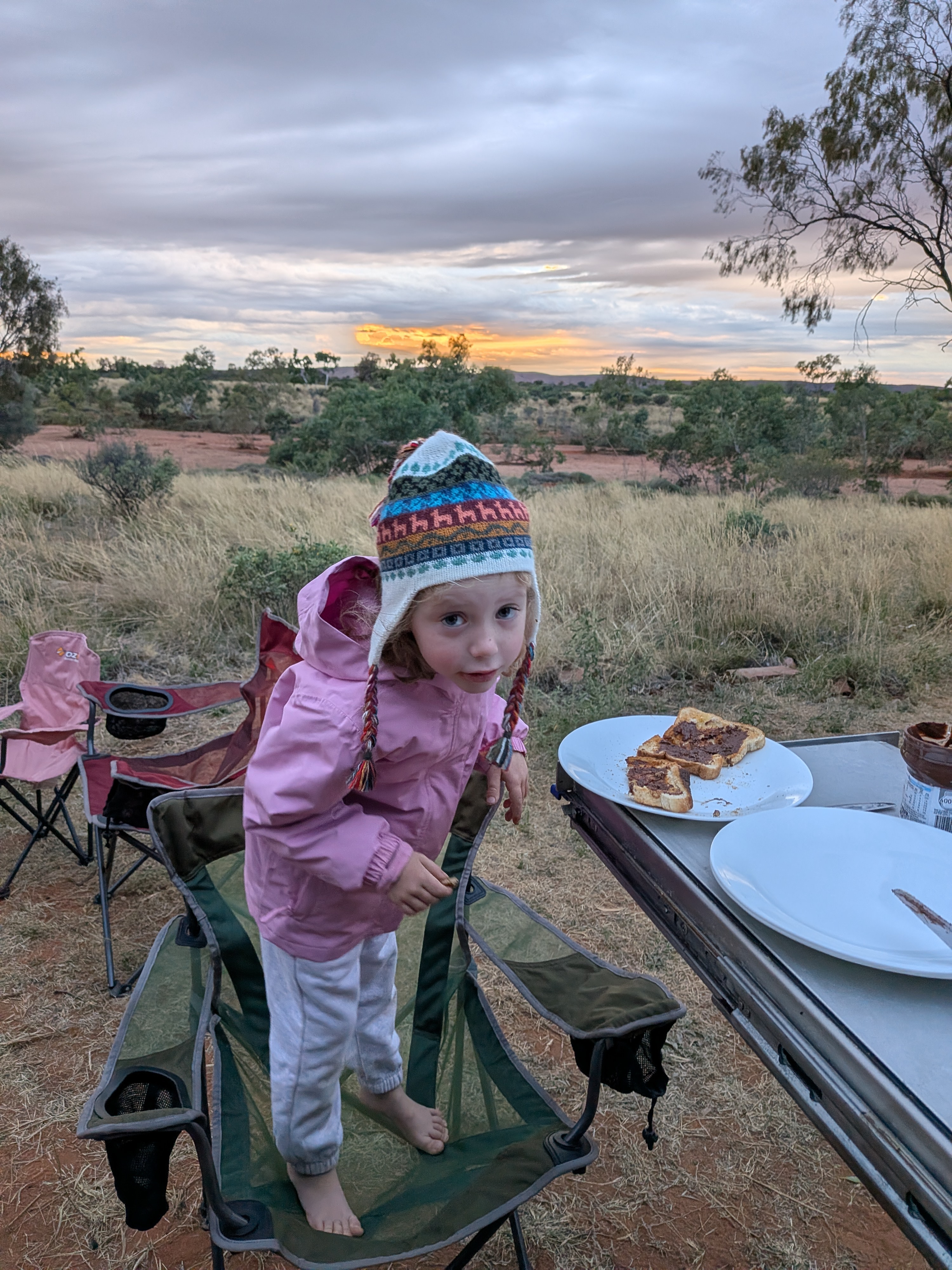 Leah rugged up in a beanie at breakfast at the Barrow Creek free camp