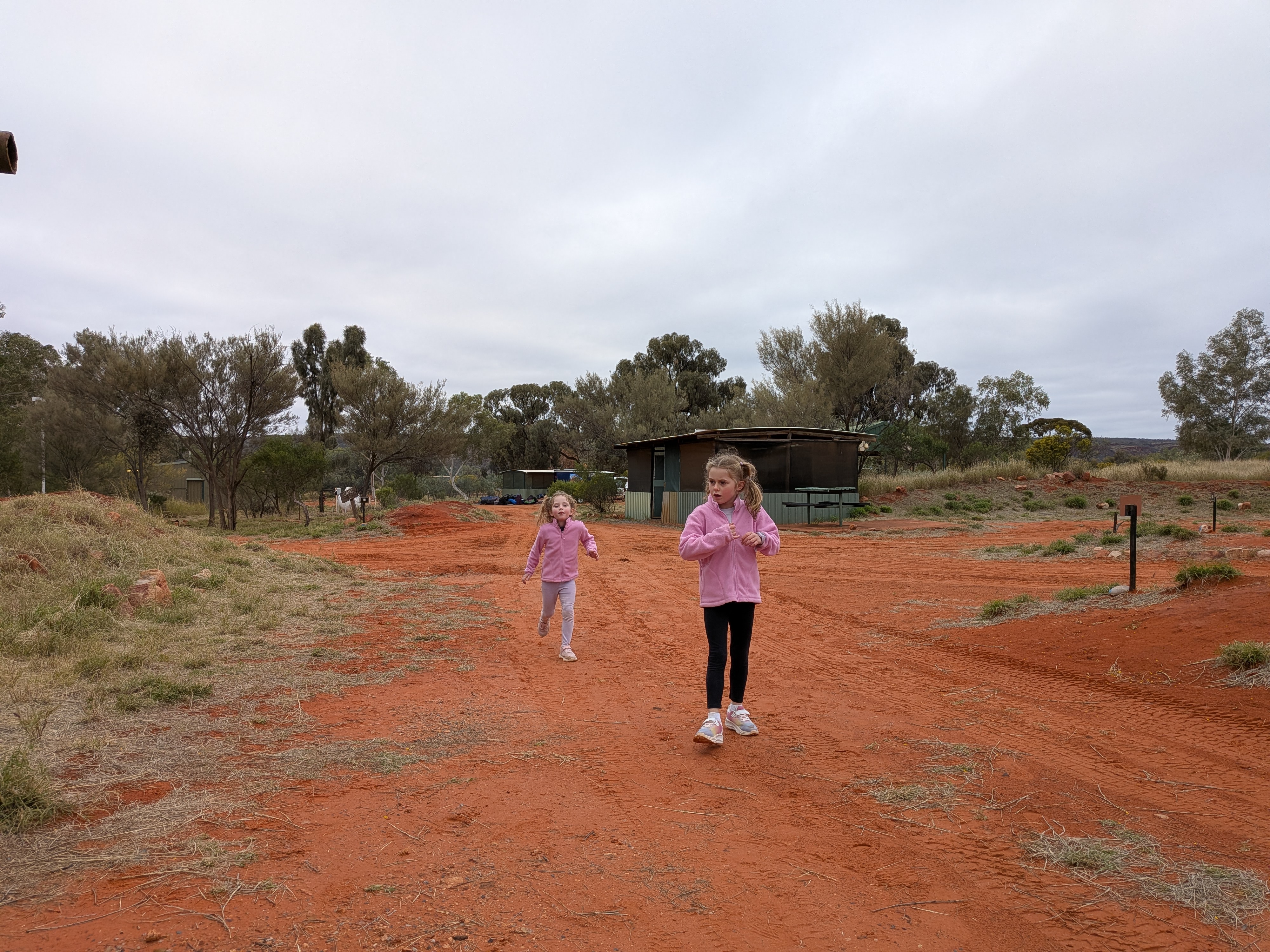 The girls running on the red dirt at Kings Creek Station