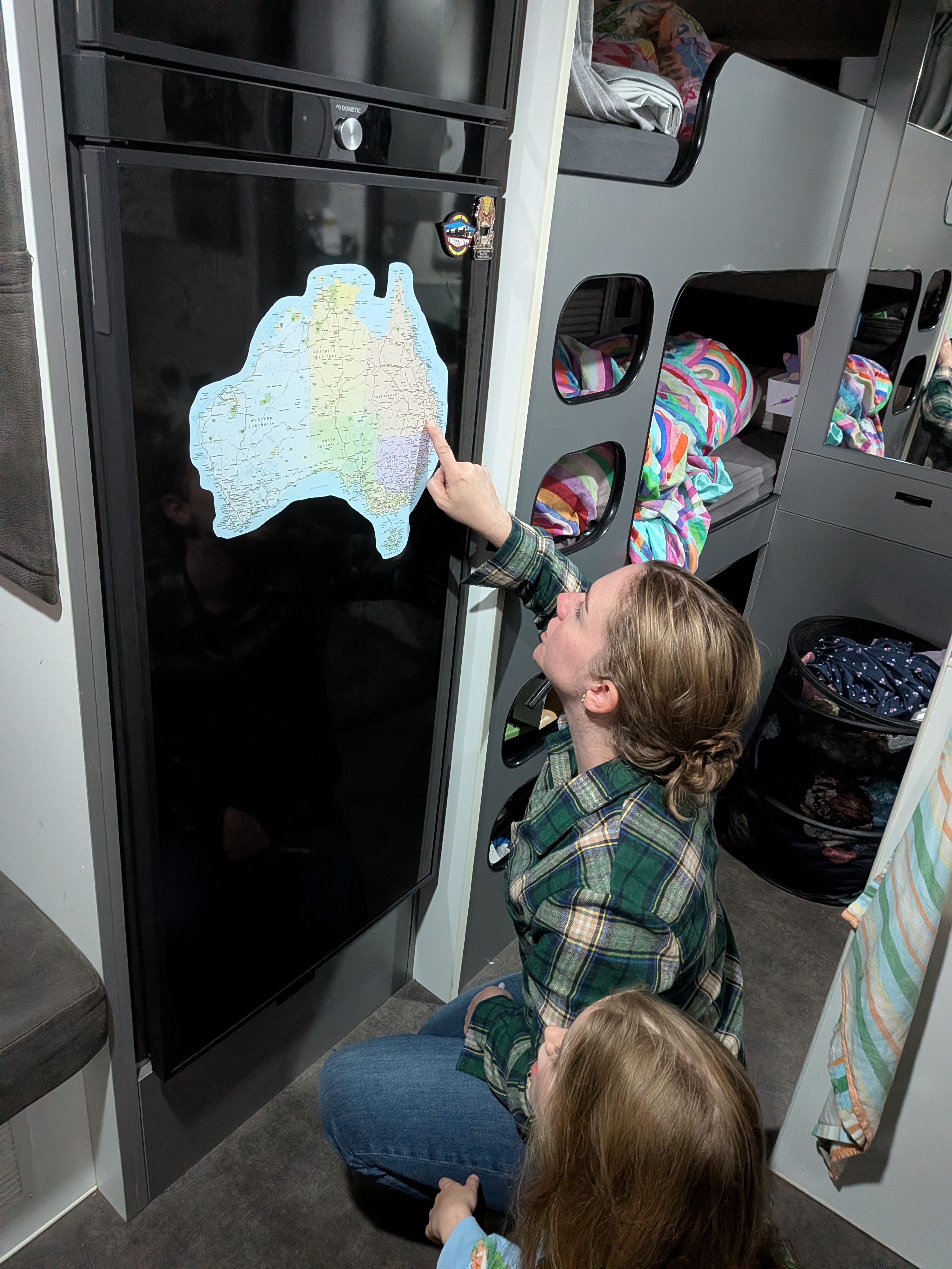 Erin and the girls looking at the Australia map on the van fridge