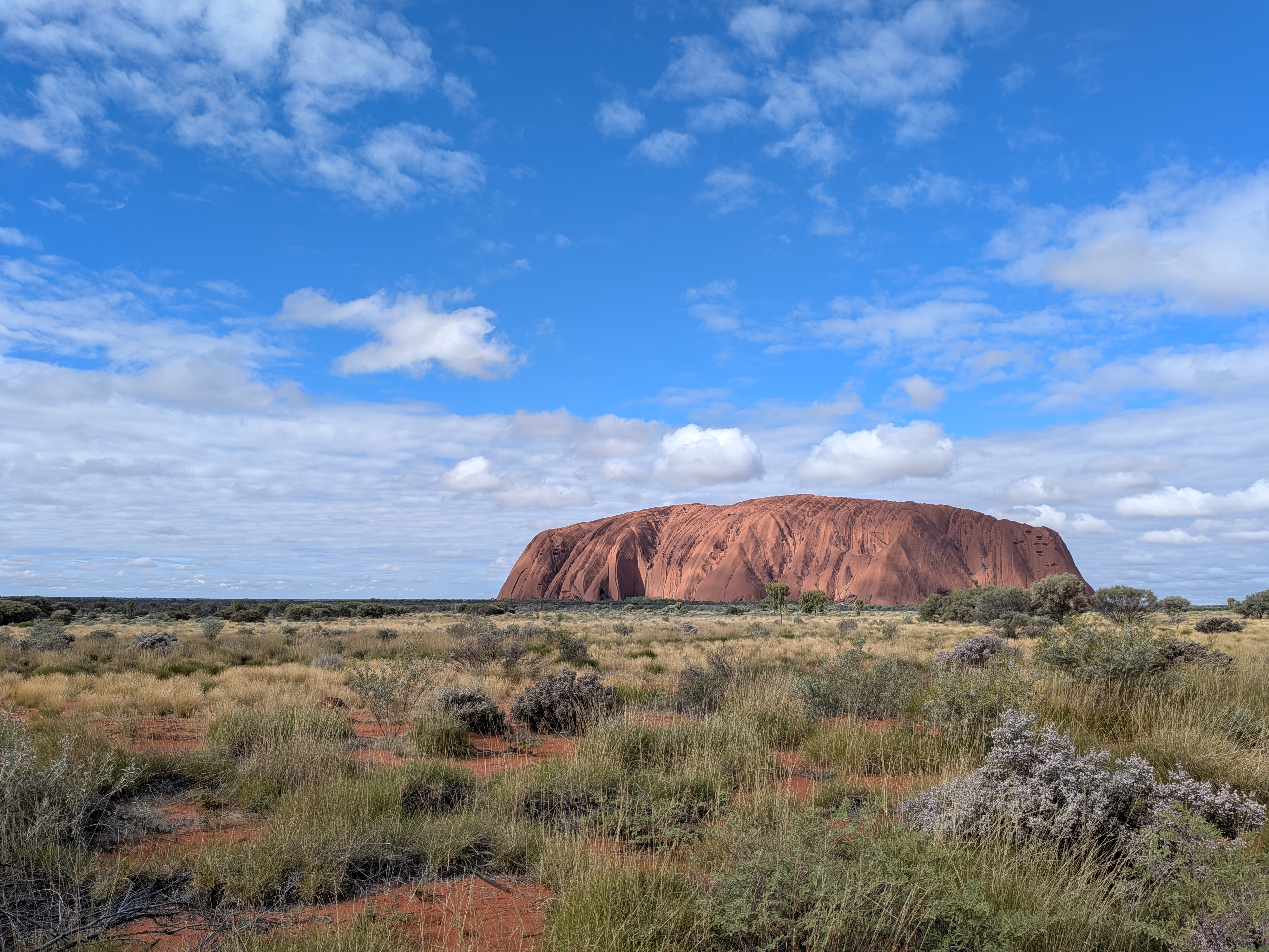 Uluru wide landscape under blue sky
