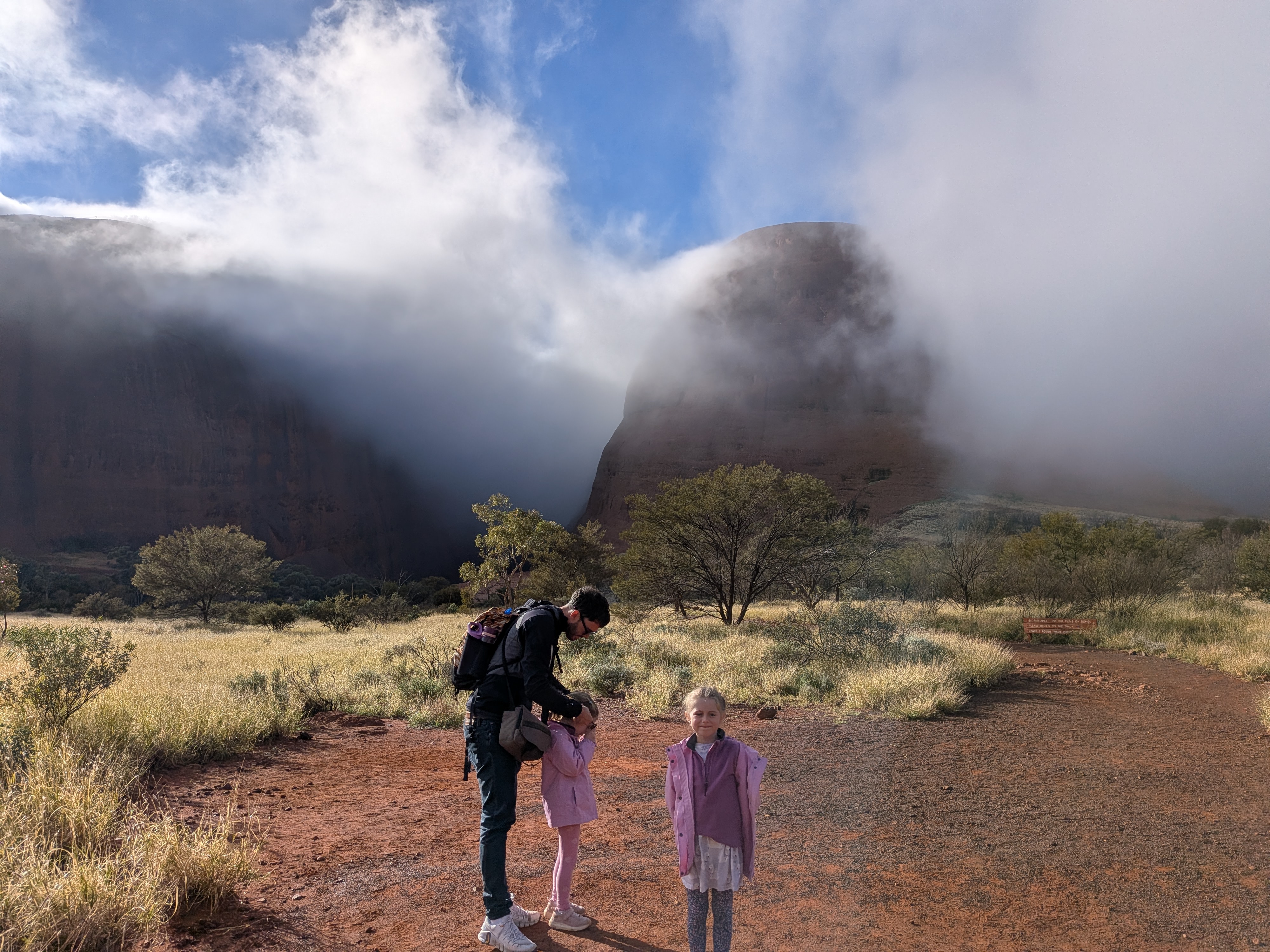 Dylan and the girls arriving at Kata Tjuta with fog swirling around the domes