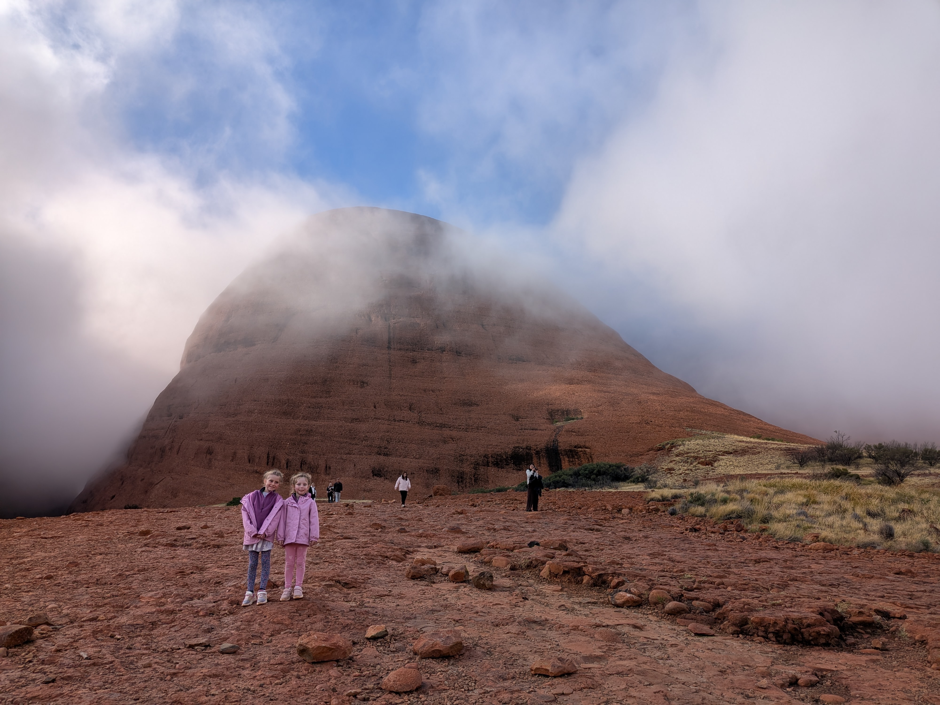 The girls with a dome emerging from the fog at Kata Tjuta