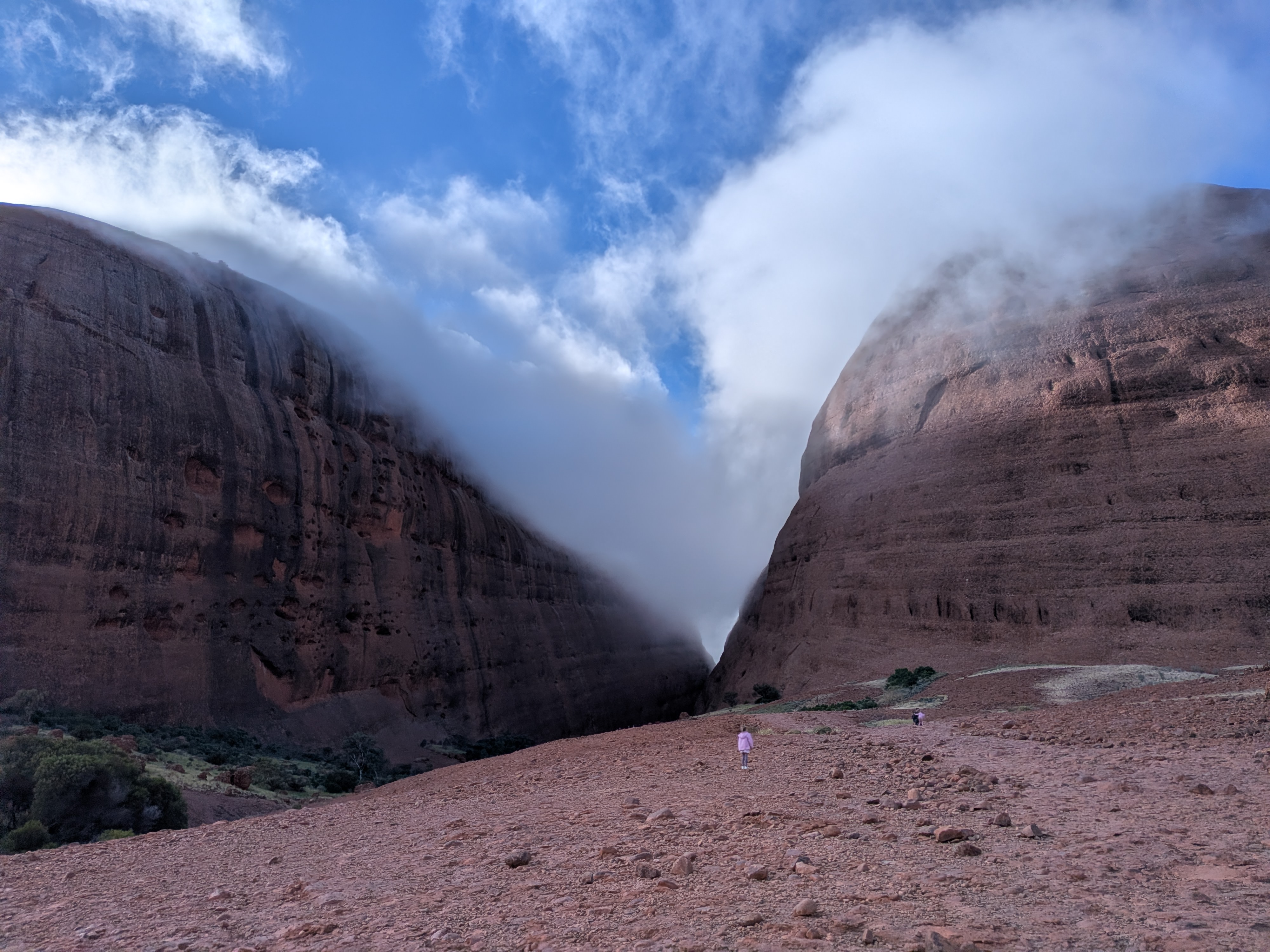 Fog pouring through Walpa Gorge — tiny figures for scale