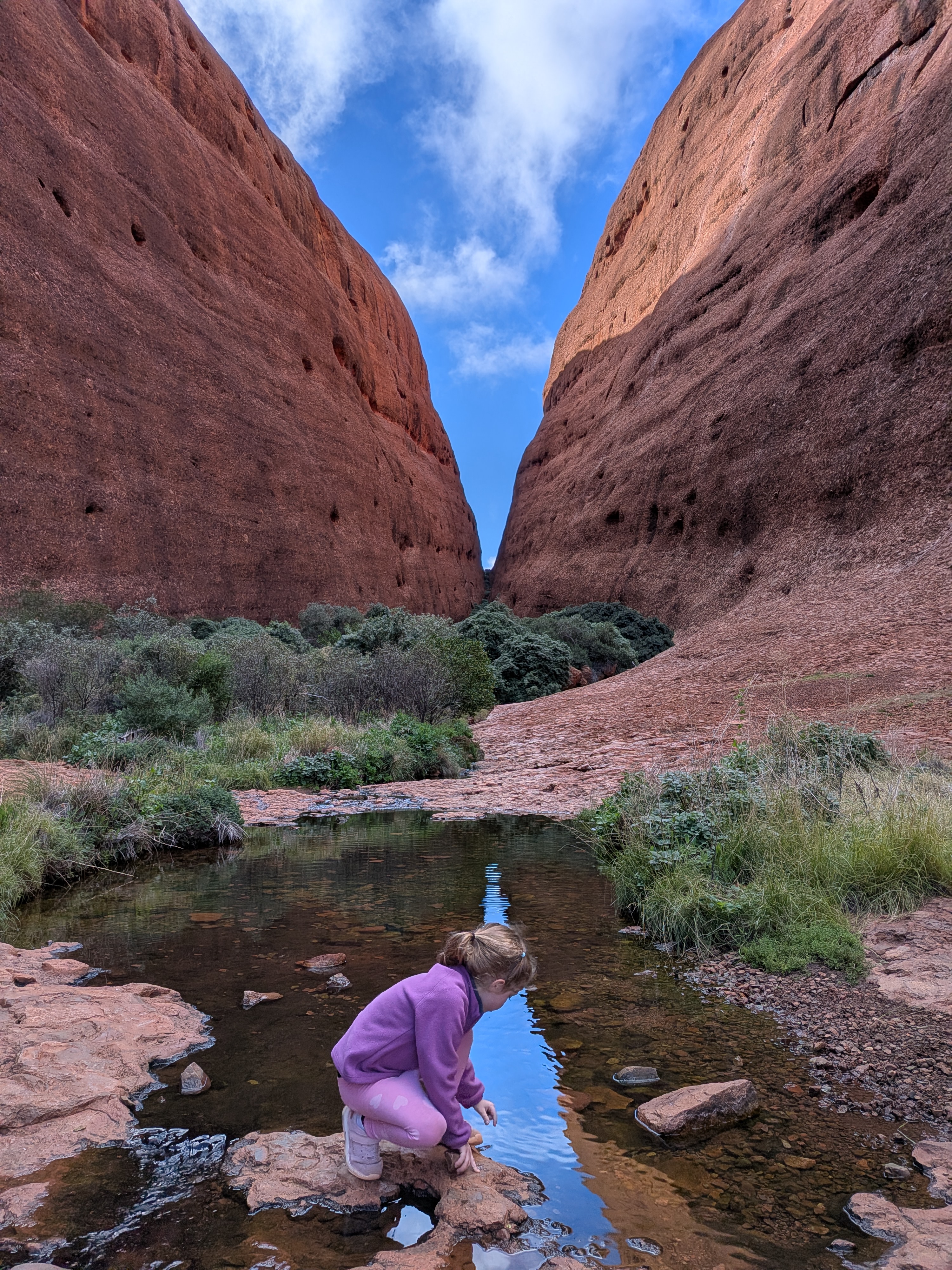 Leah at the waterhole in Walpa Gorge with reflections in the water