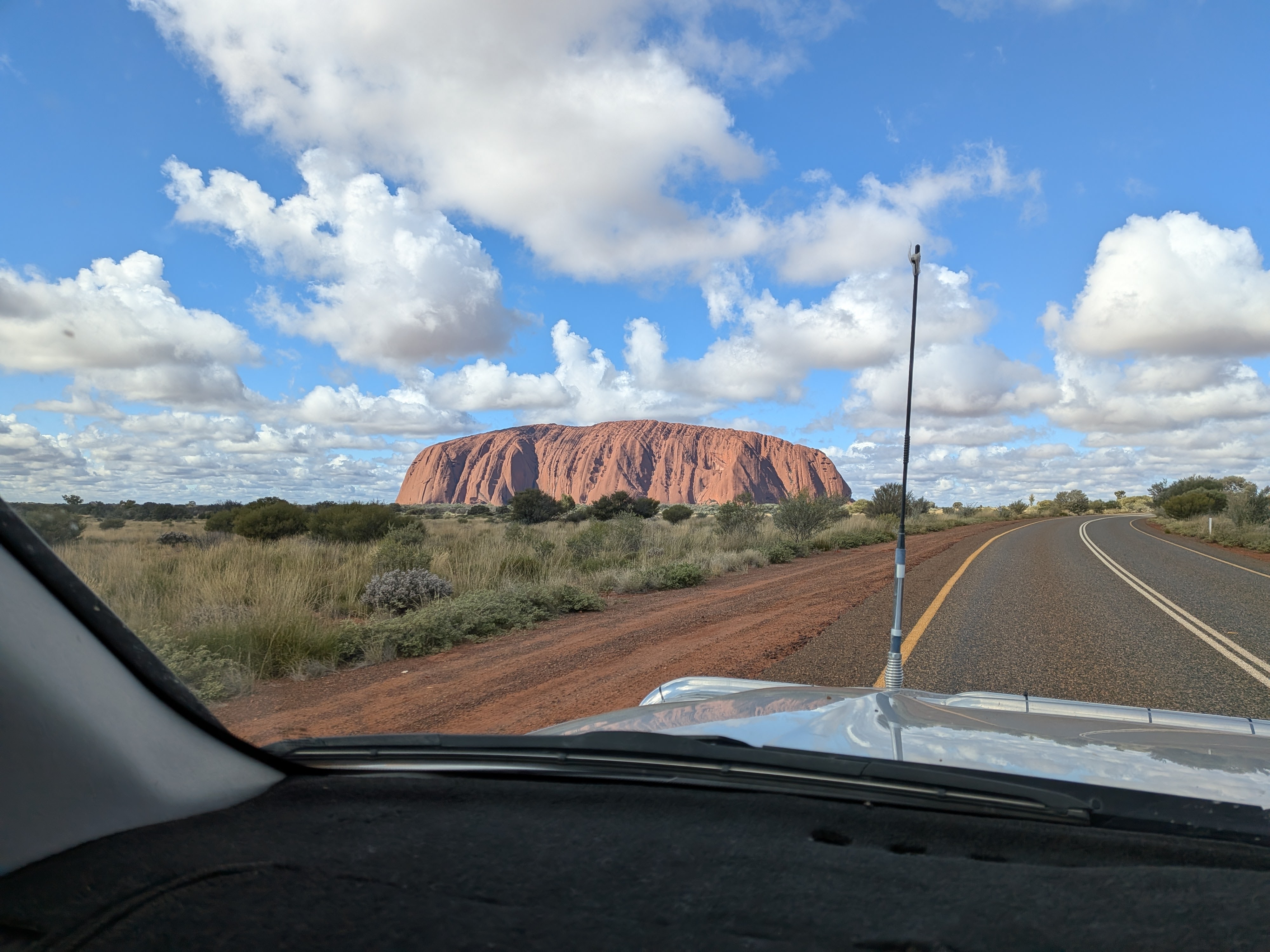 Uluru from the road through the windscreen