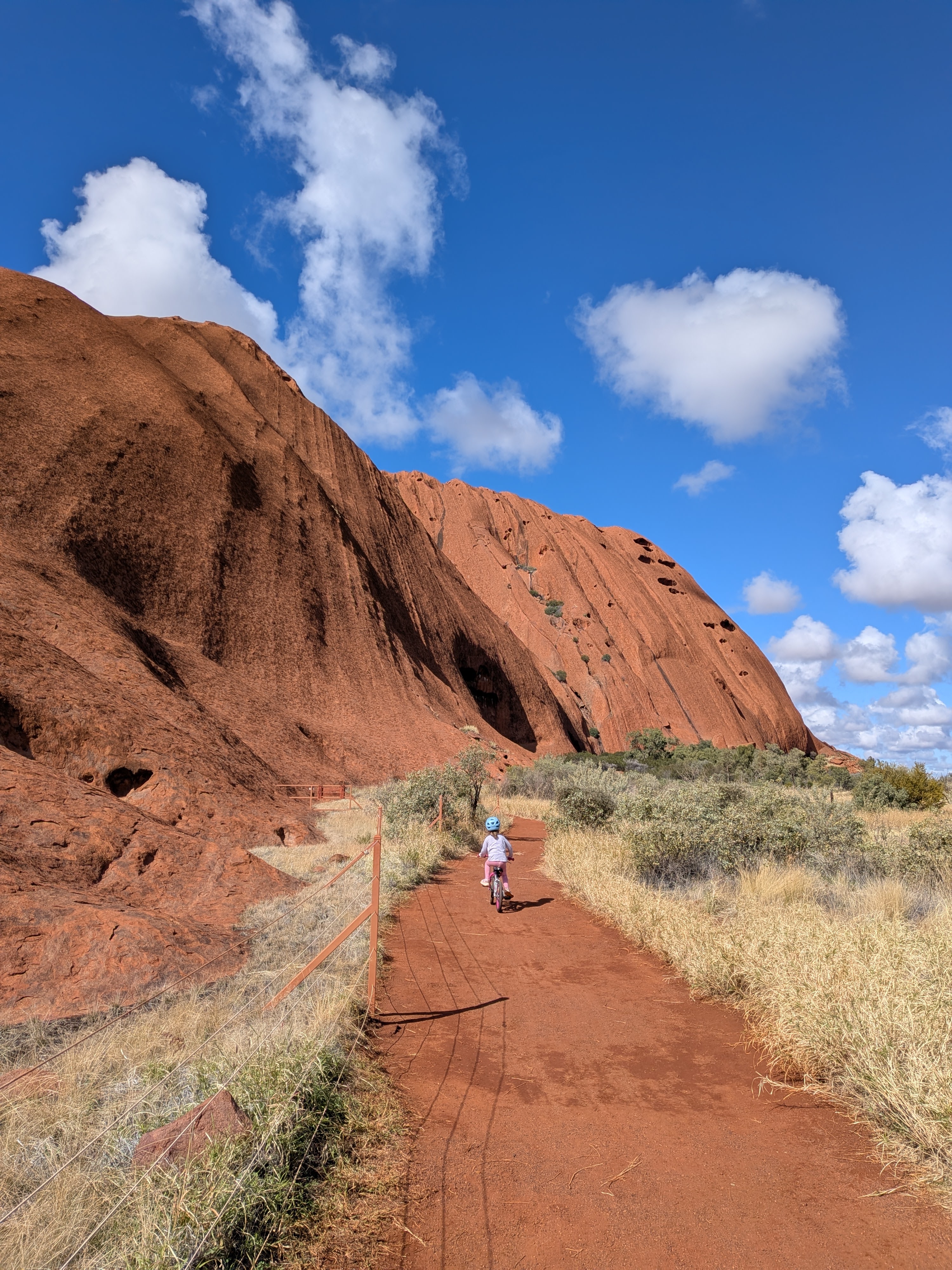 Leah walking the sandy path at the base of Uluru