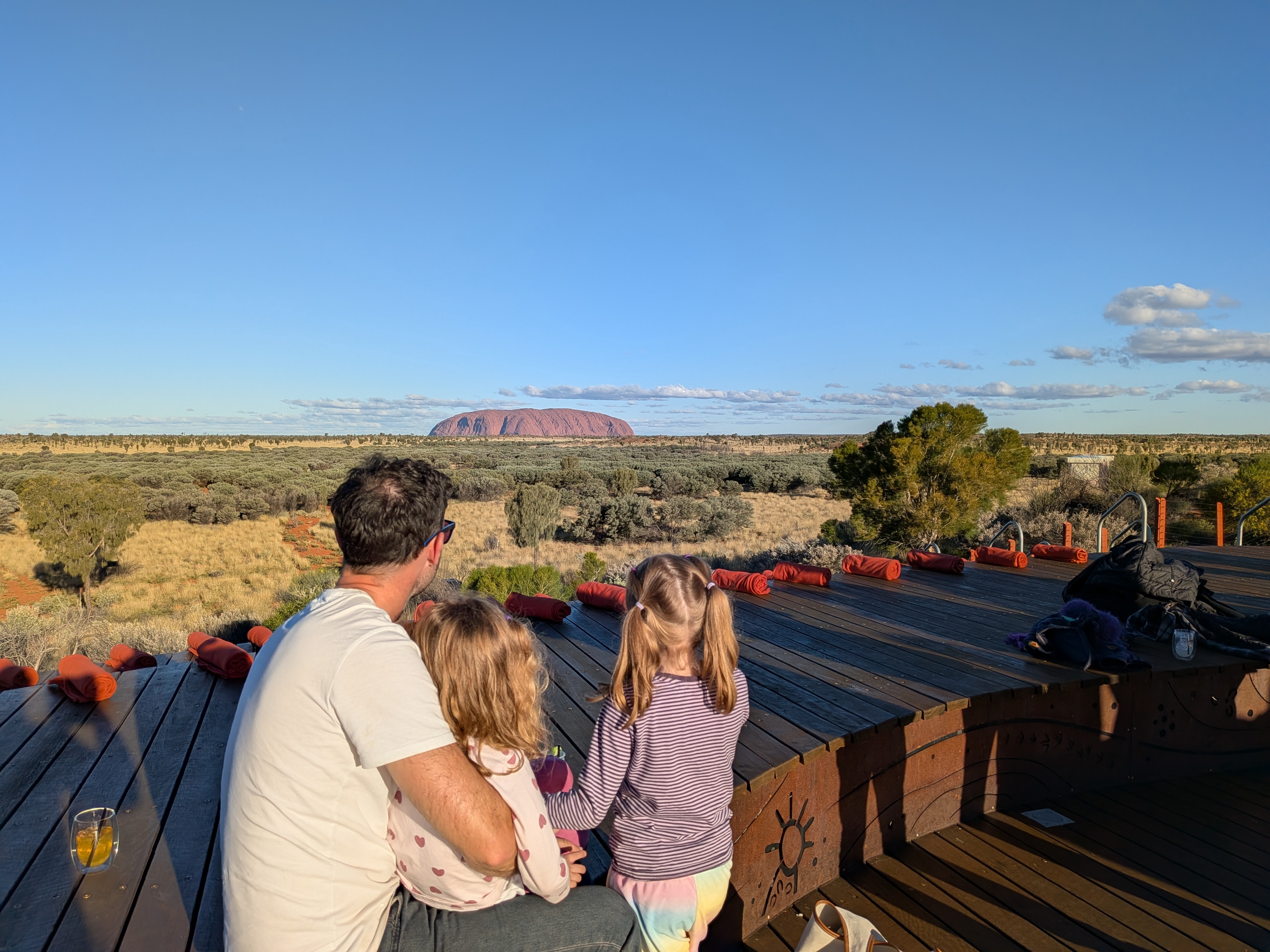 Dylan and the girls looking out at Uluru from the Wintjiri Wiru deck