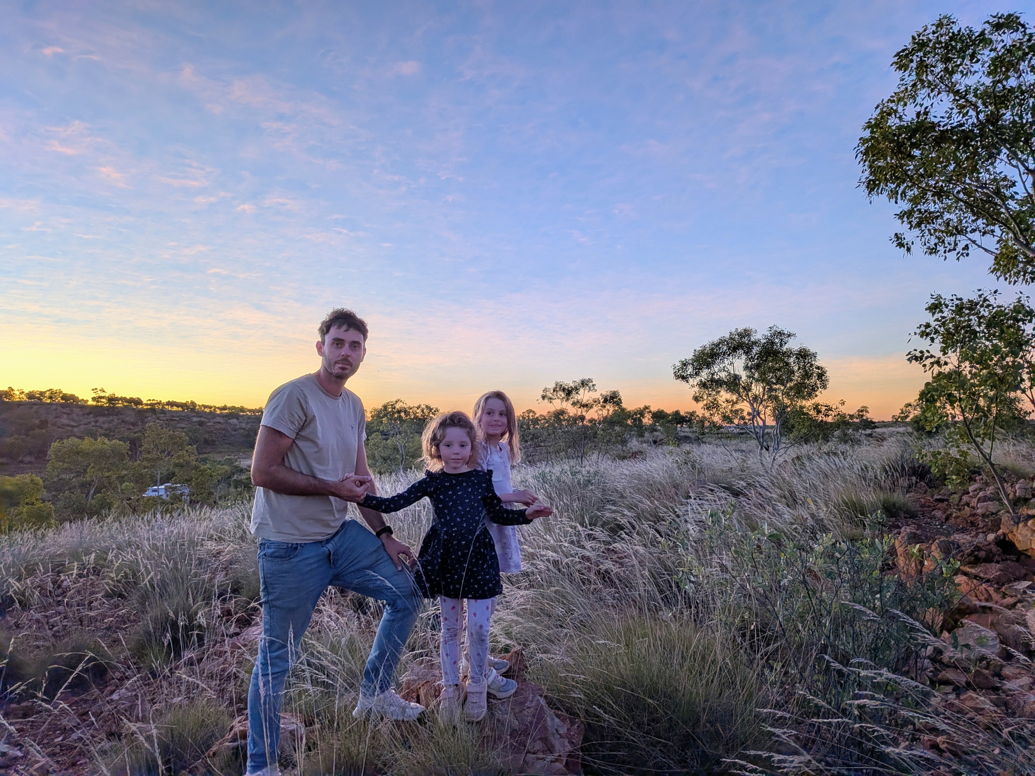 Dylan, Leah and Hazel in the long golden grass on the hill at sunset