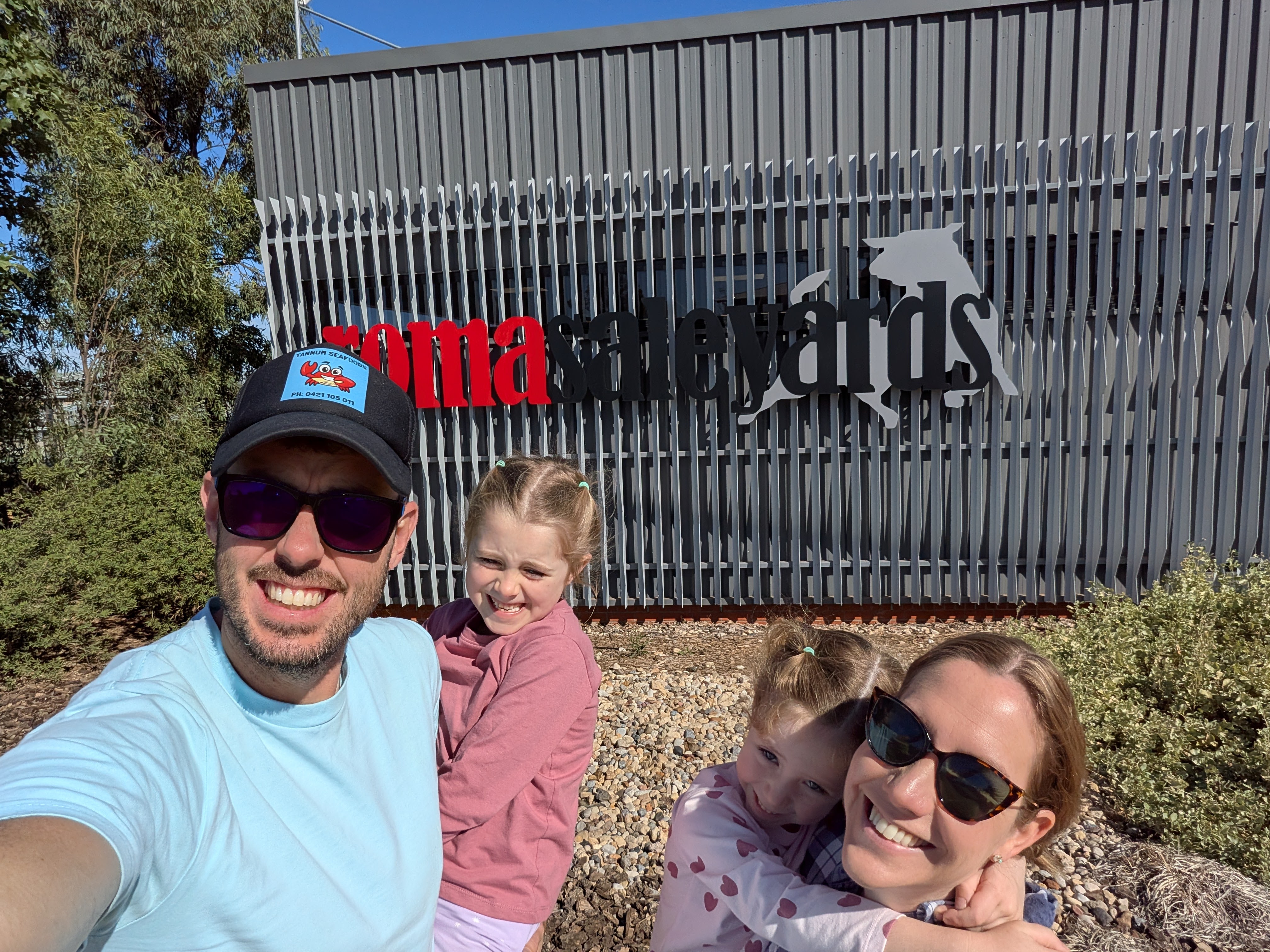 Family selfie at the Roma Saleyards sign
