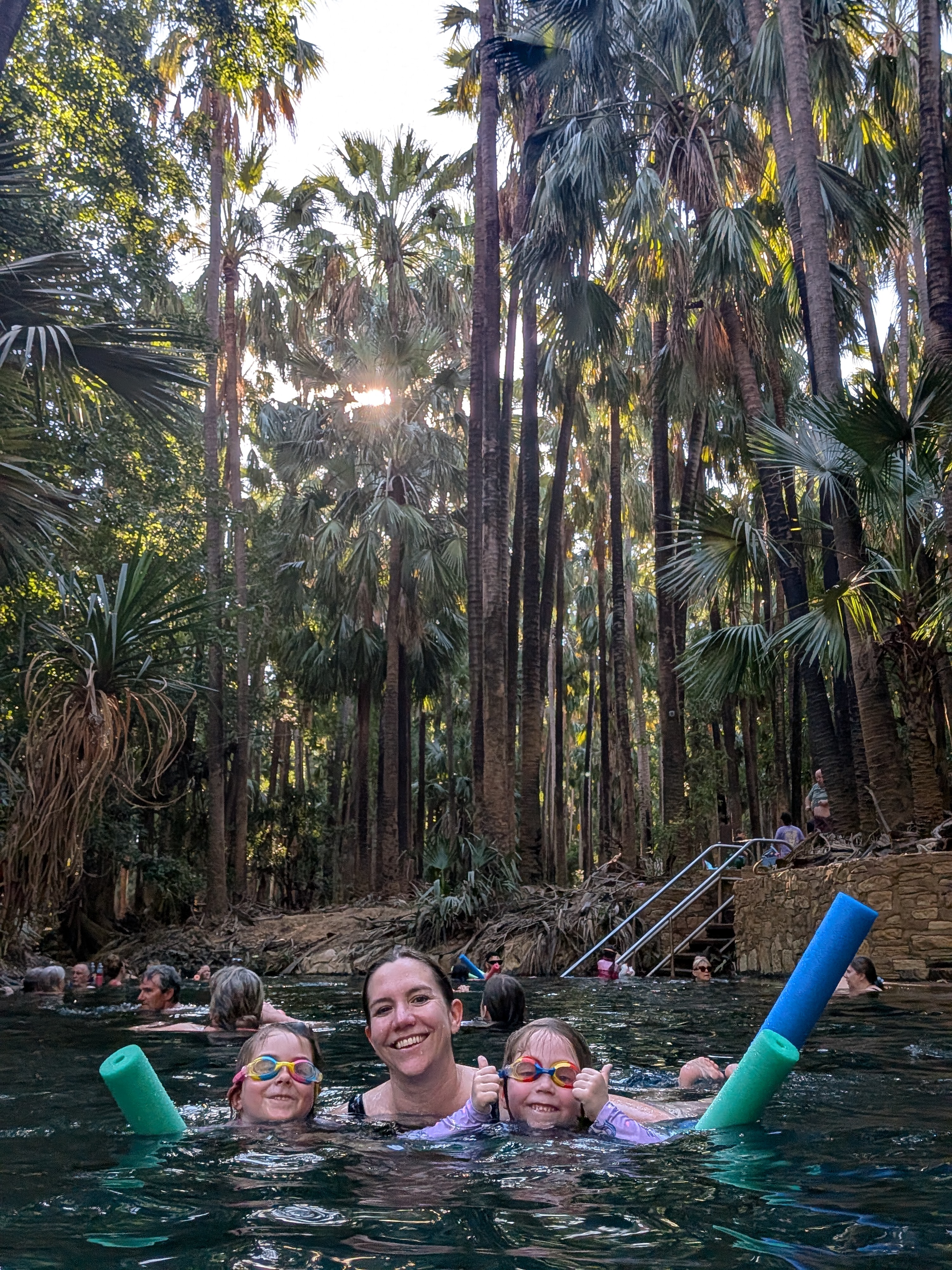 Erin and the girls in the thermal pool, Leah giving a double thumbs up