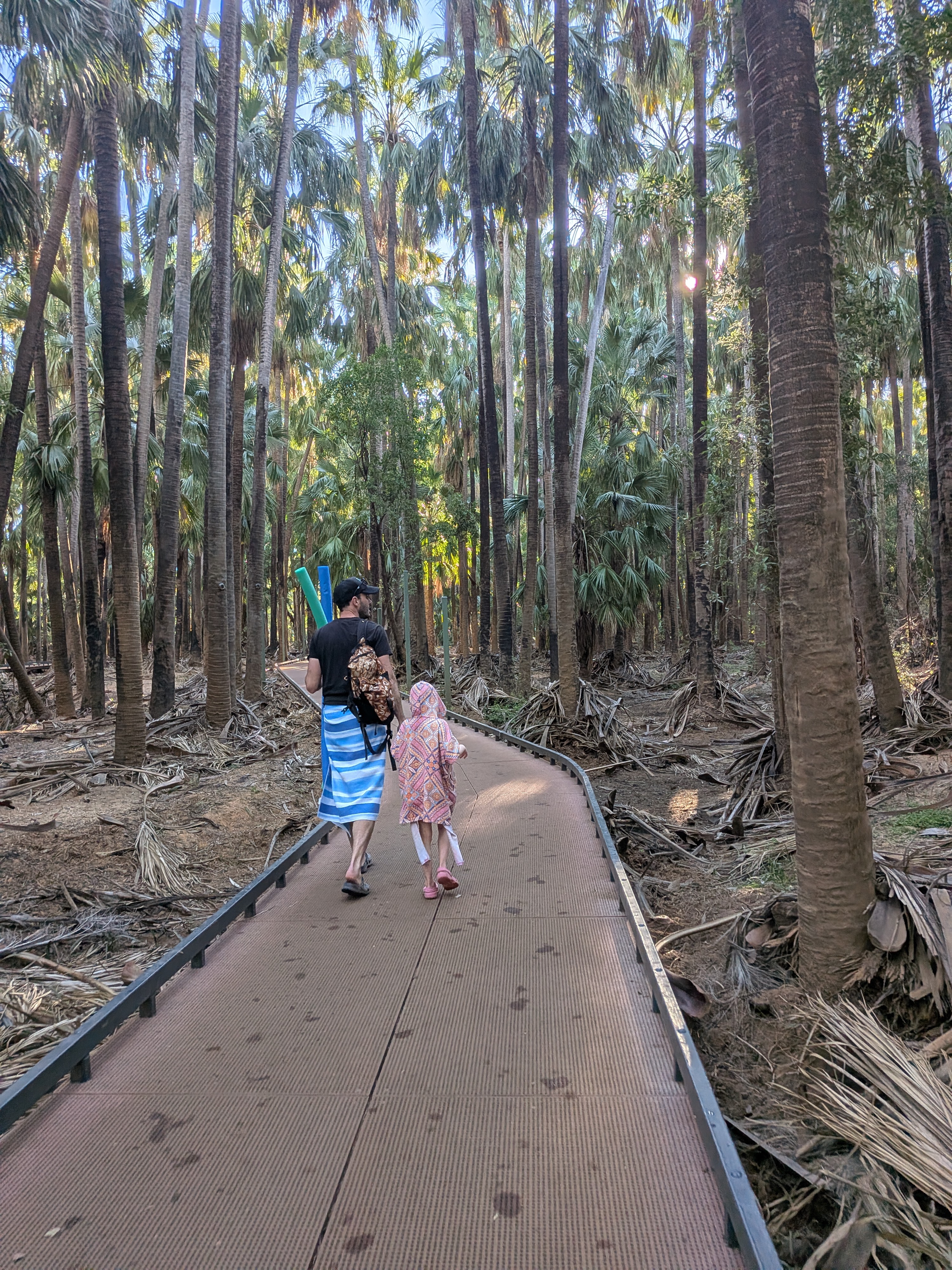 Dylan and Leah in her hooded towel walking the boardwalk back from the pool