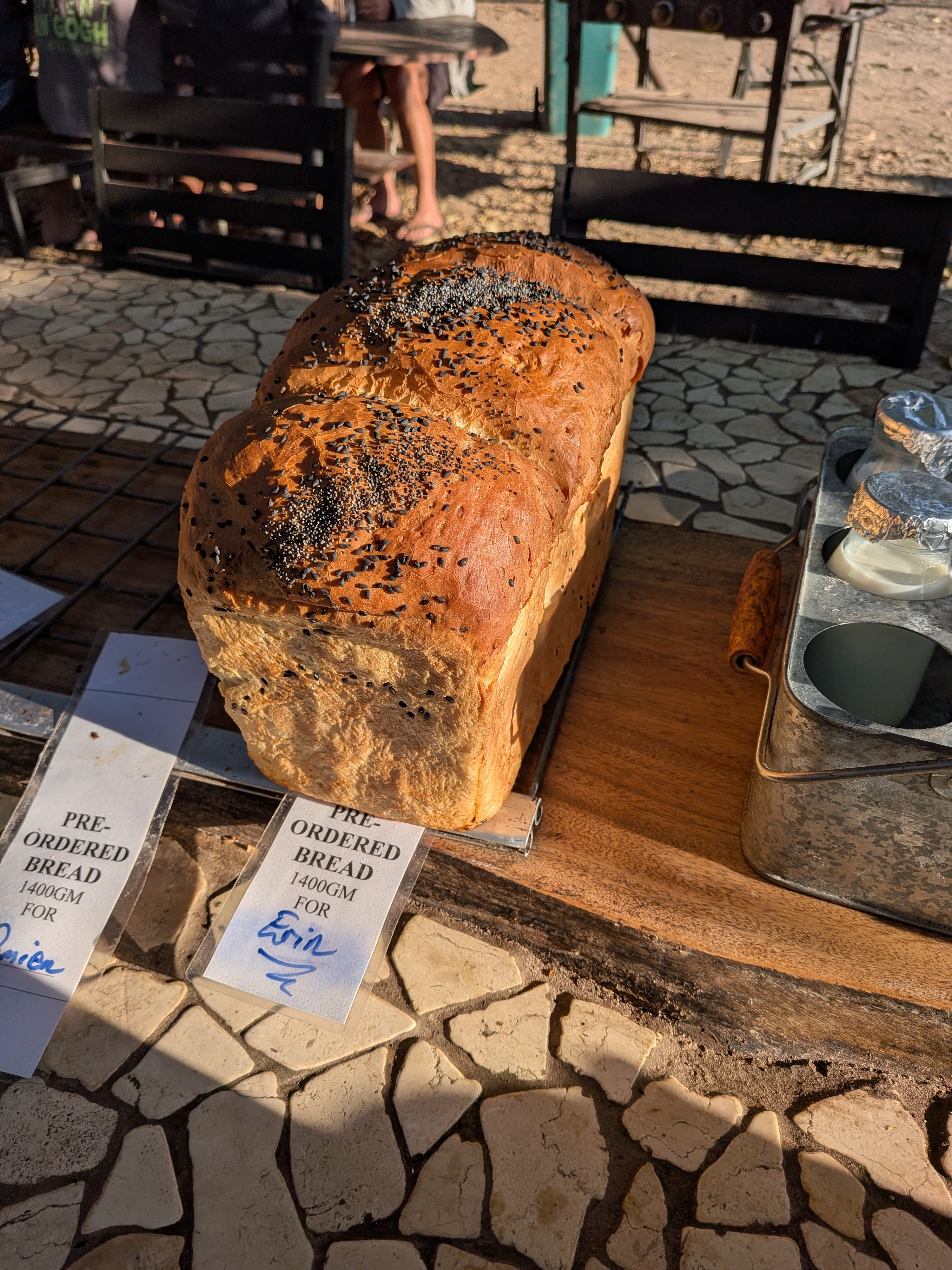 The freshly baked loaf on the rack with its Pre-Ordered Bread for Erin label