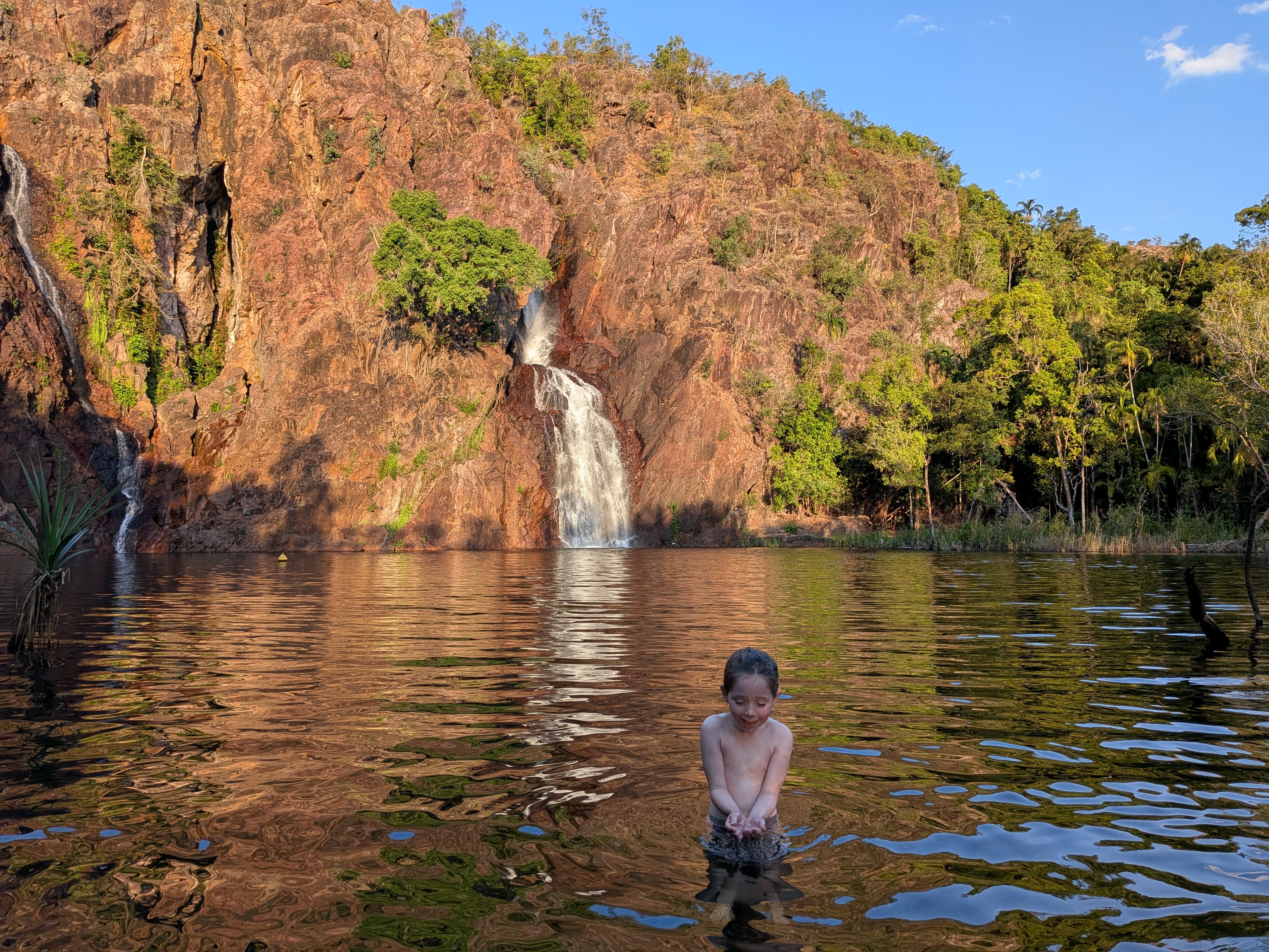 Hazel chest-deep in the plunge pool, scooping up the water