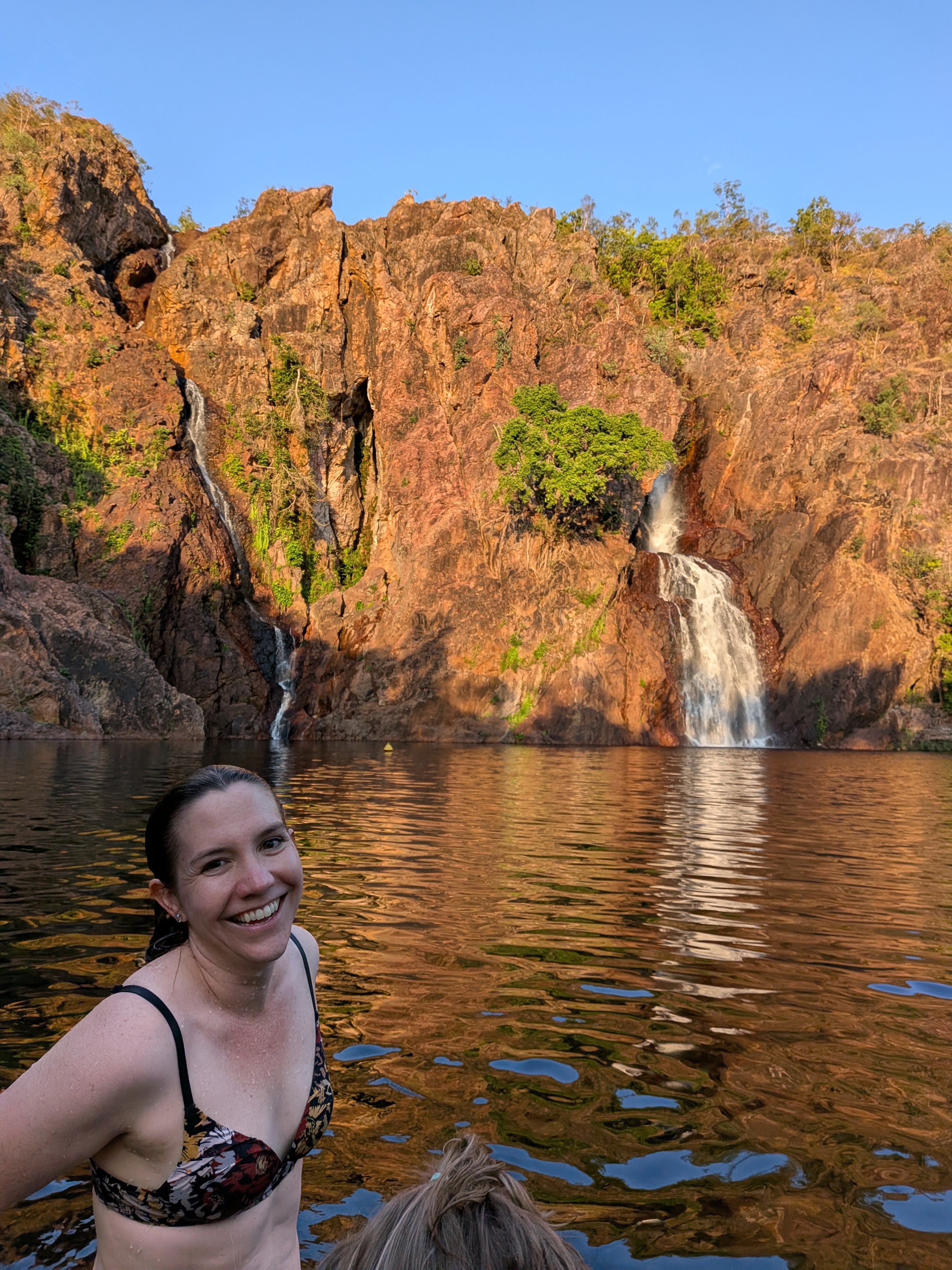 Erin in the plunge pool with the falls behind