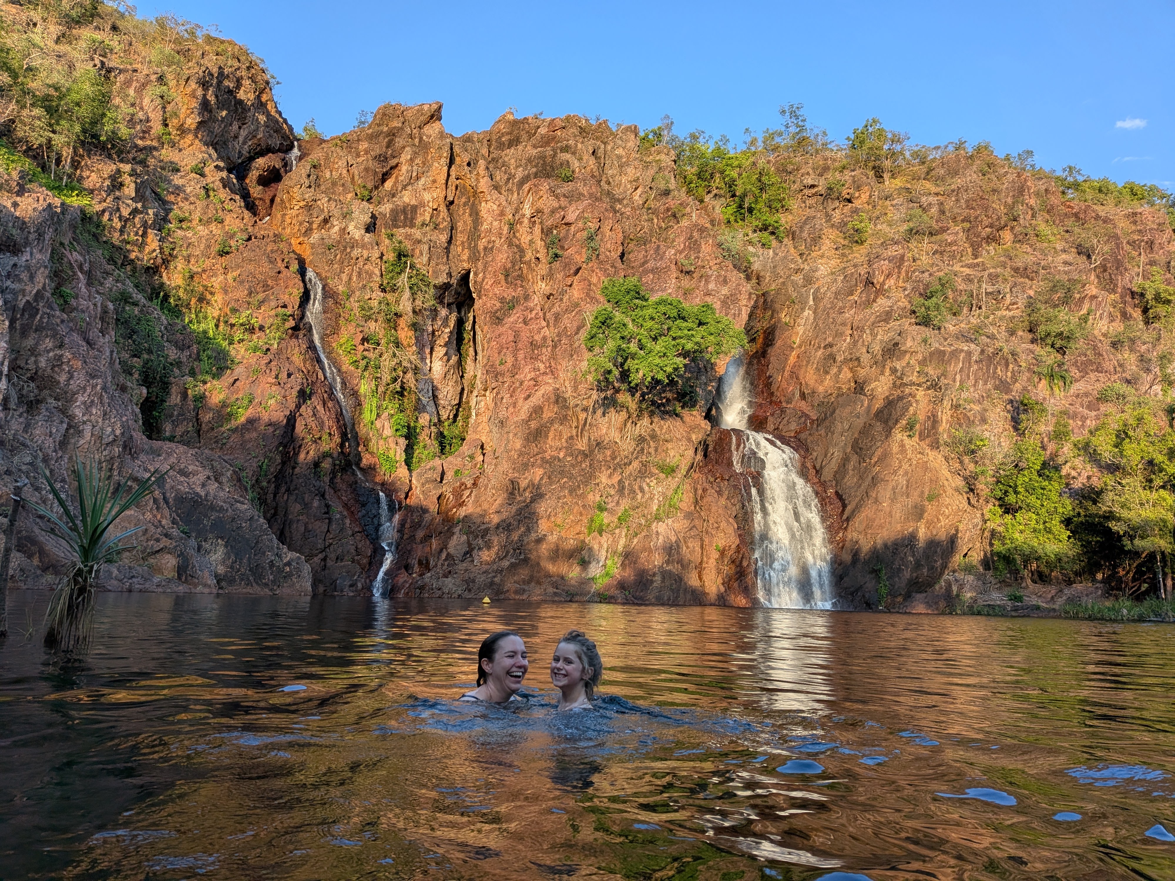 Erin and Hazel cheek-to-cheek, laughing in the water