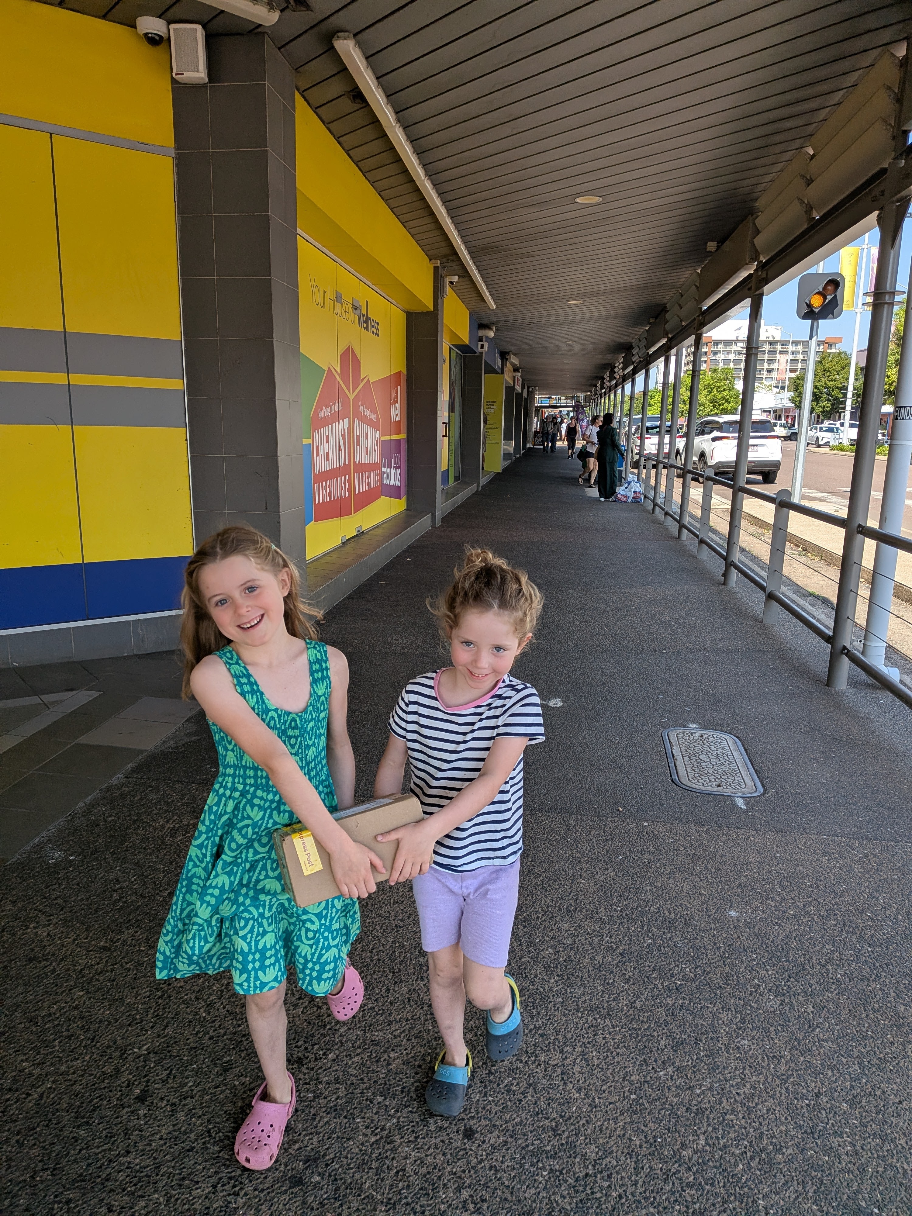 Hazel and Leah carrying the post office parcels through the city together
