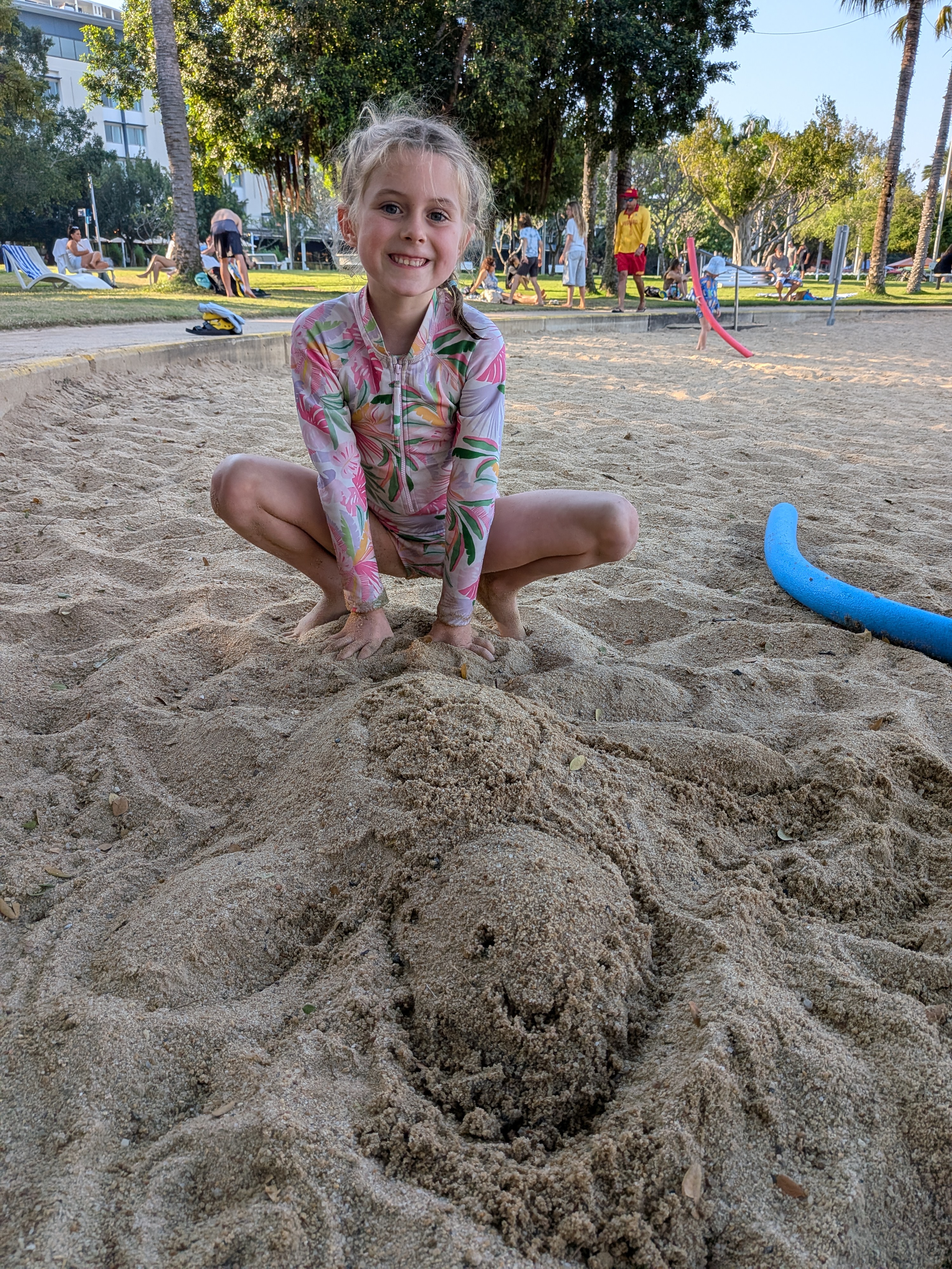Hazel with her crocodile sand sculpture on the lagoon beach