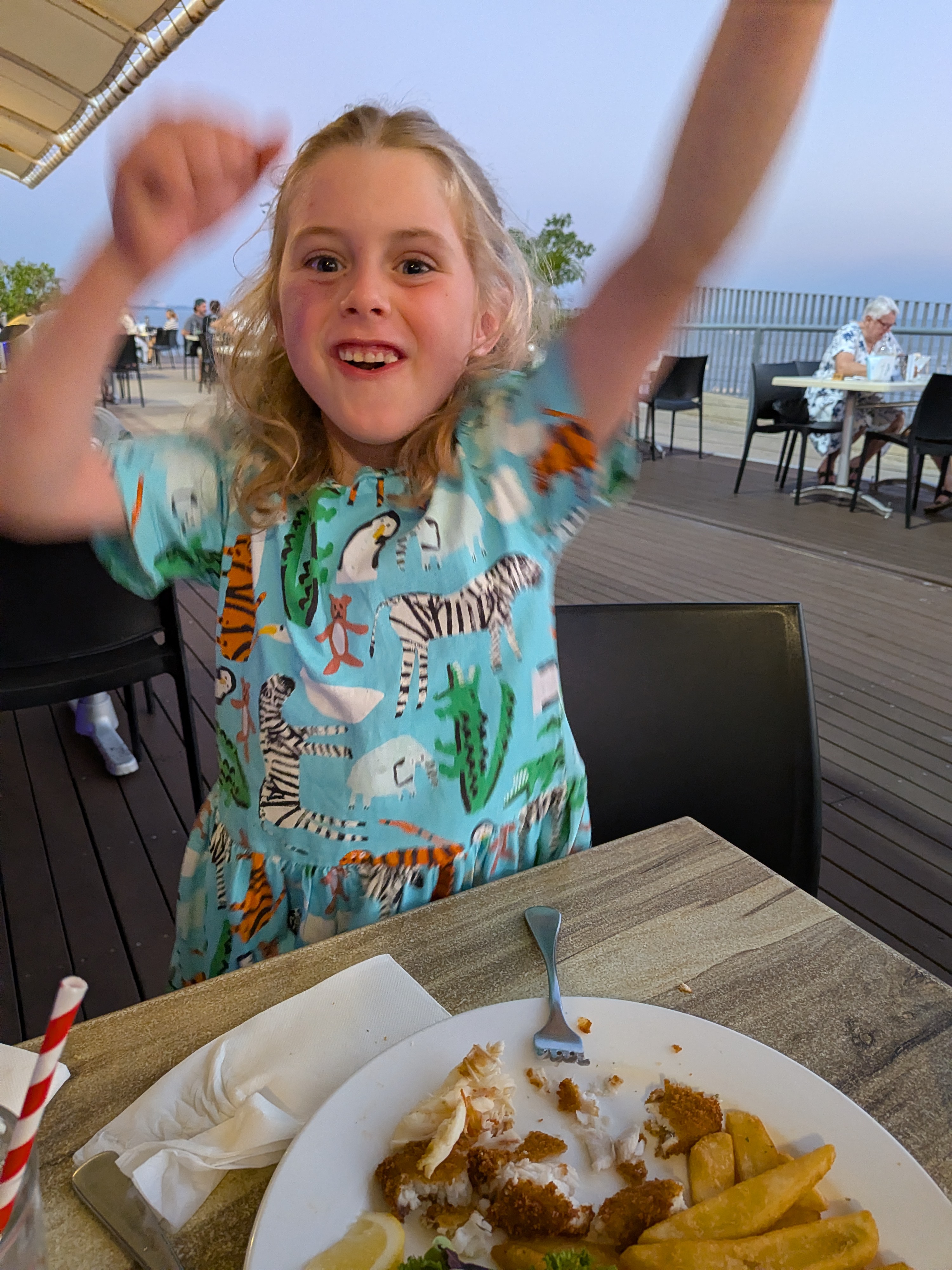 Hazel celebrating her fish and chips (and first ever Moreton Bay Bug) at the wharf