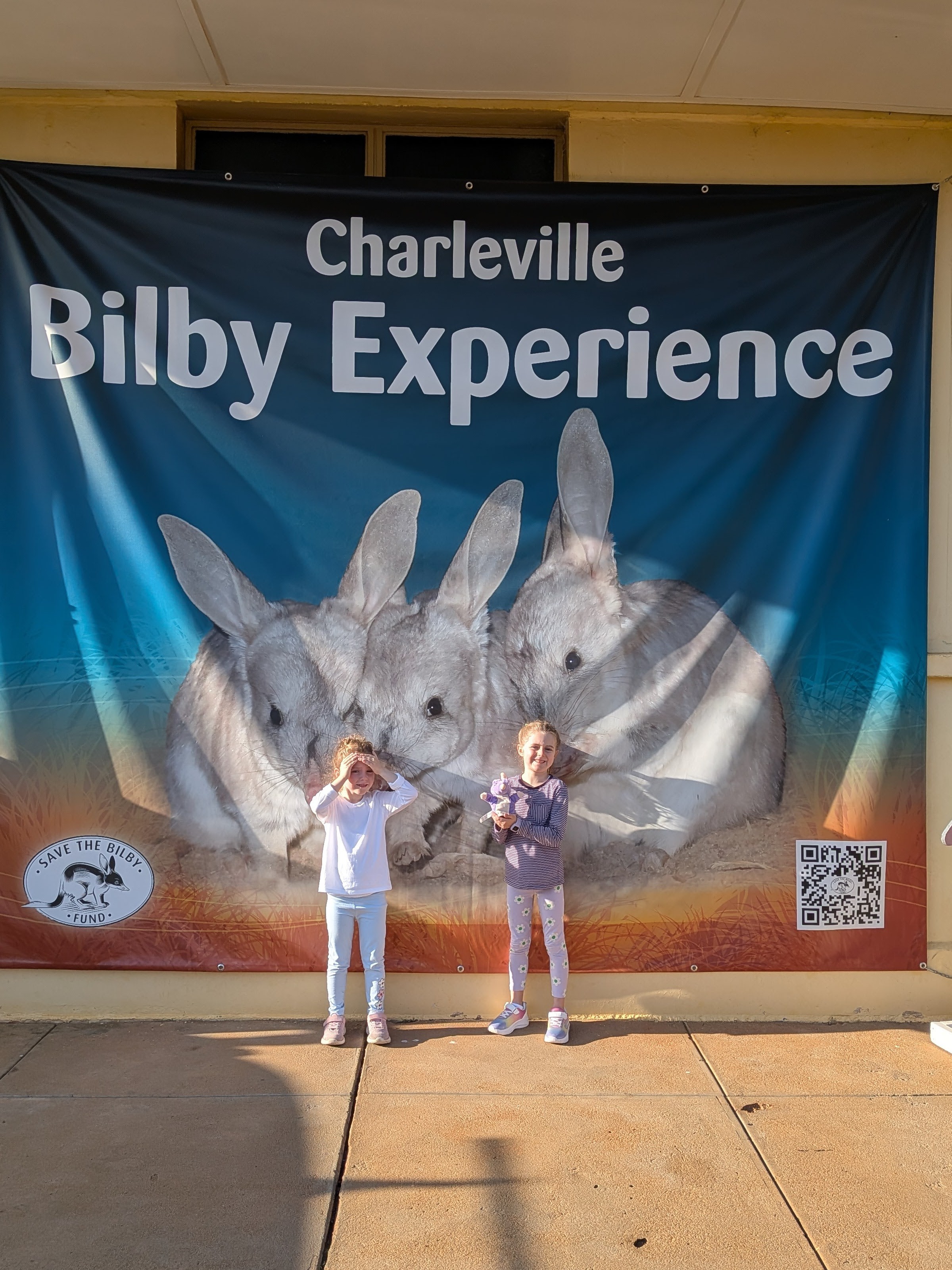 Hazel and Leah in front of the Charleville Bilby Experience banner
