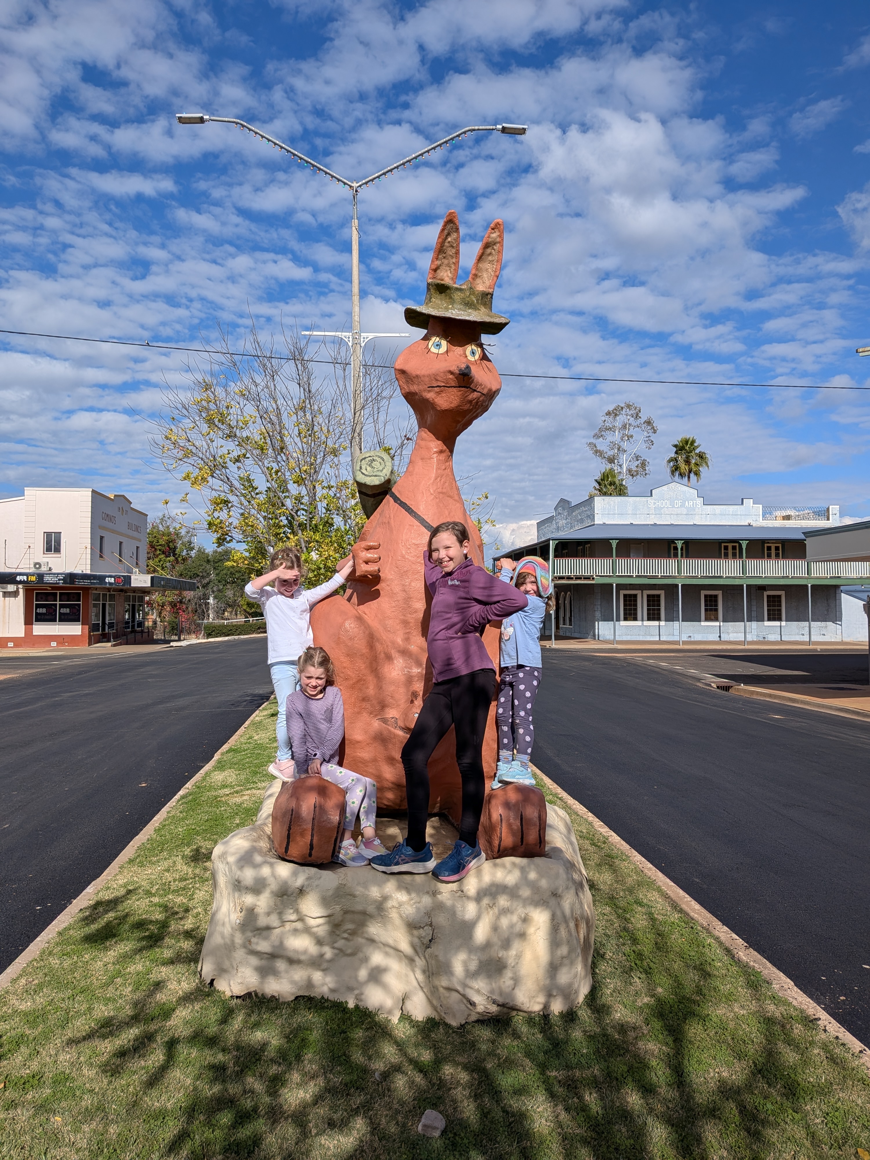 Family posing with the big kangaroo statue on Charleville main street