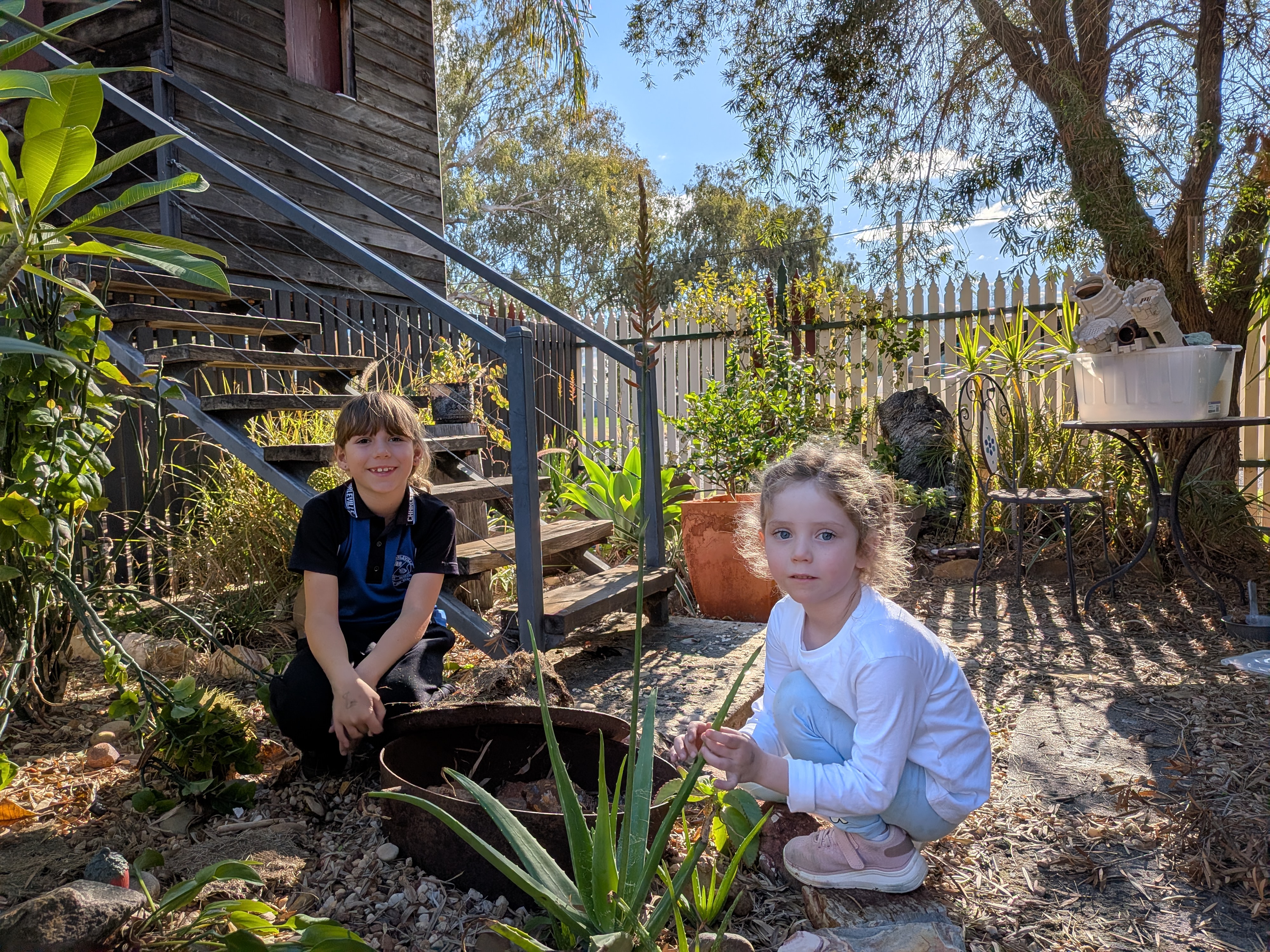 Hazel and Leah exploring the backyard garden