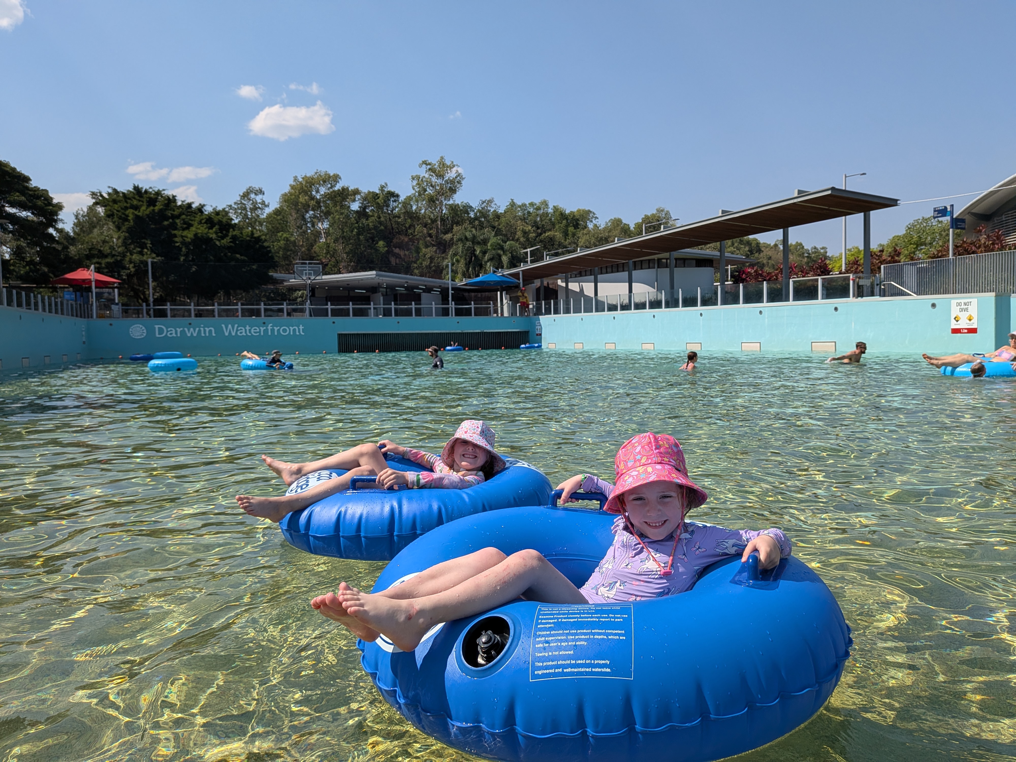 Hazel and Leah riding the waves in their tubes at the Darwin Waterfront Wave Lagoon