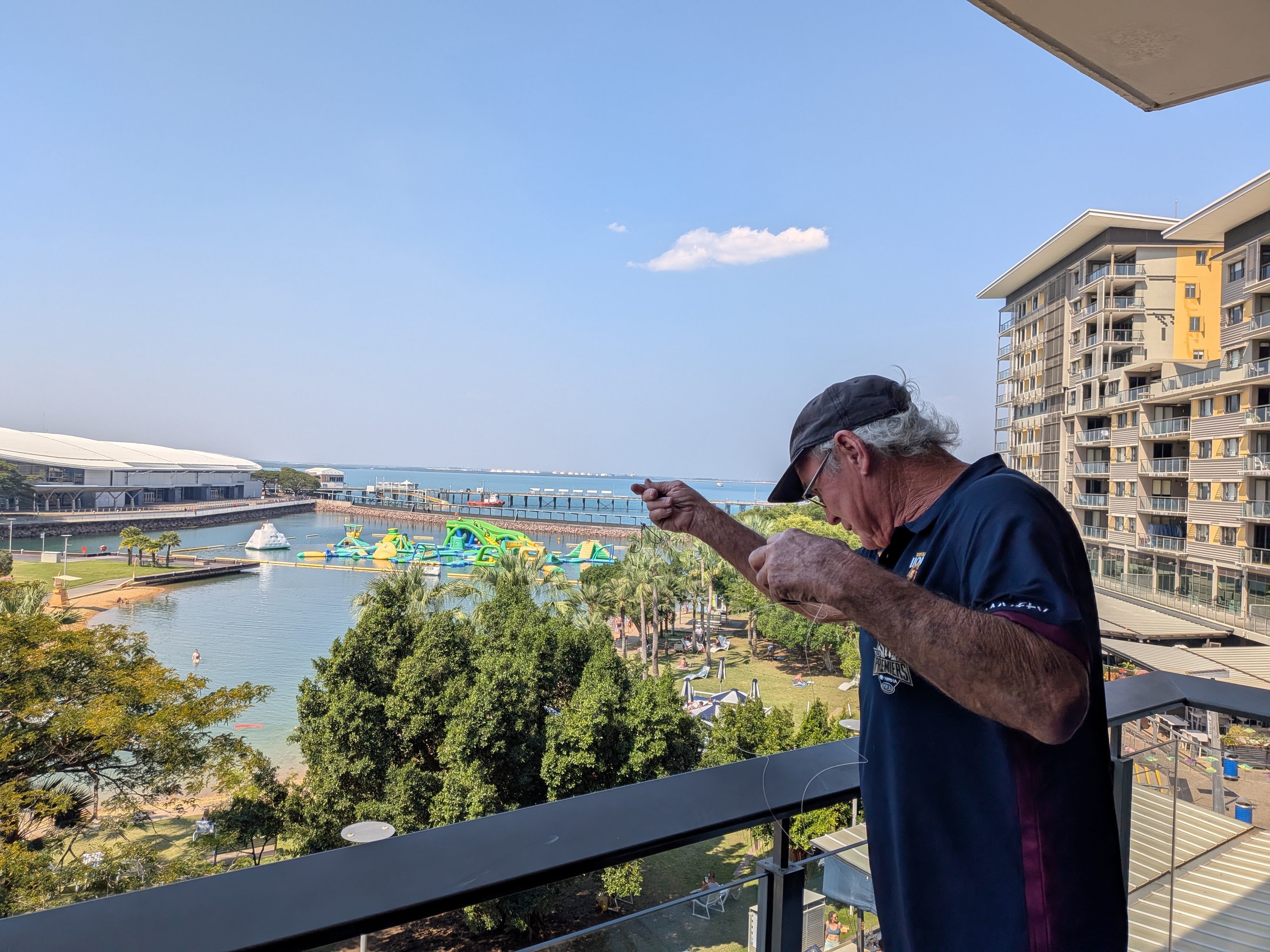 Pa on our balcony rigging up his specially made rod and hooking device
