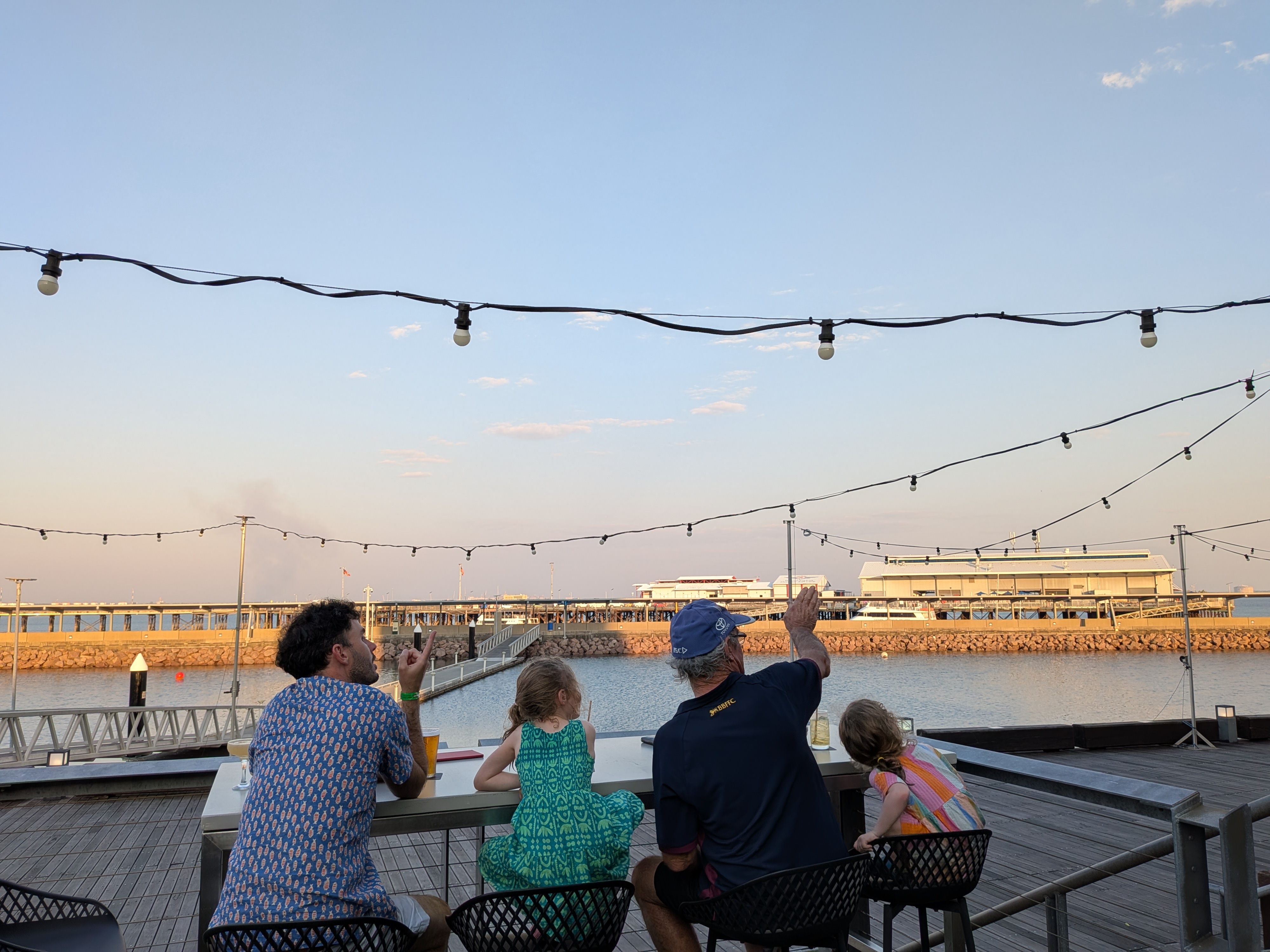Plane spotting at the bar &mdash; Dylan and Pa pointing out the jets to the girls