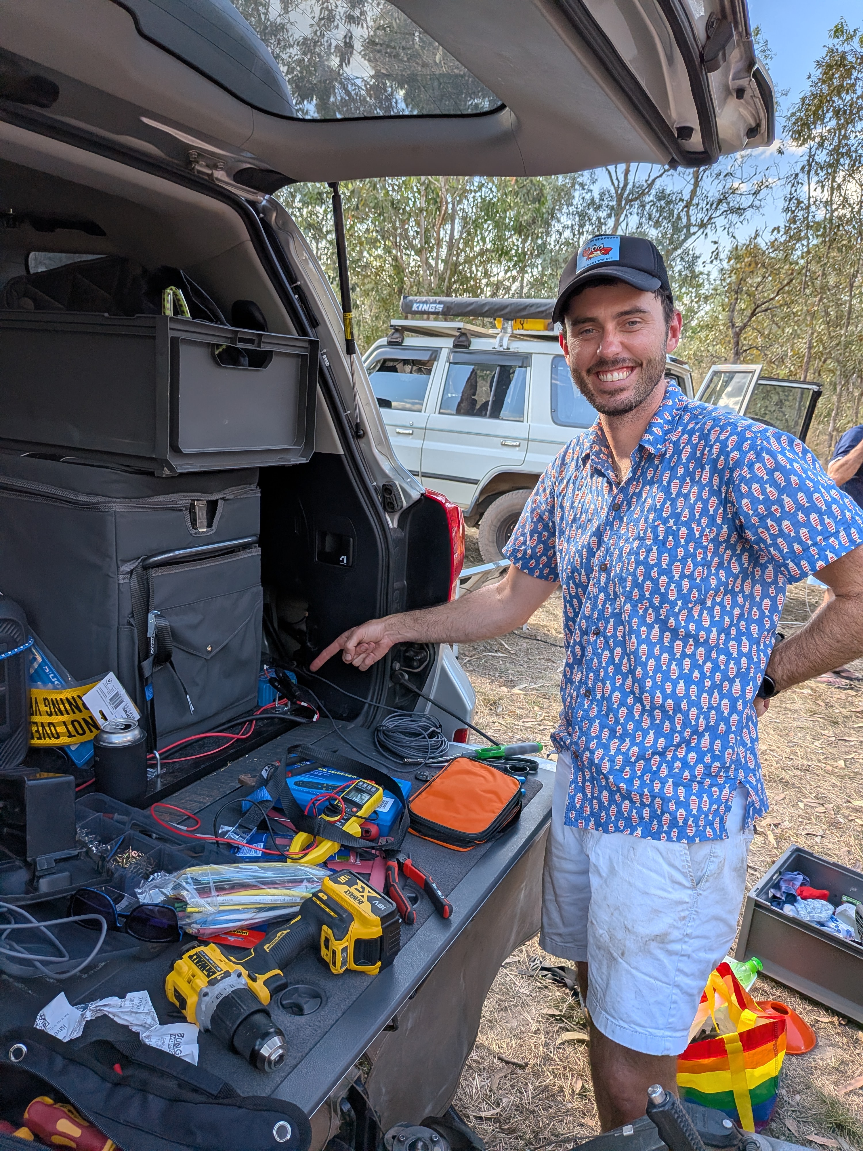 Dylan pointing out his electrical handiwork on the Bluetti setup in the back of Reg