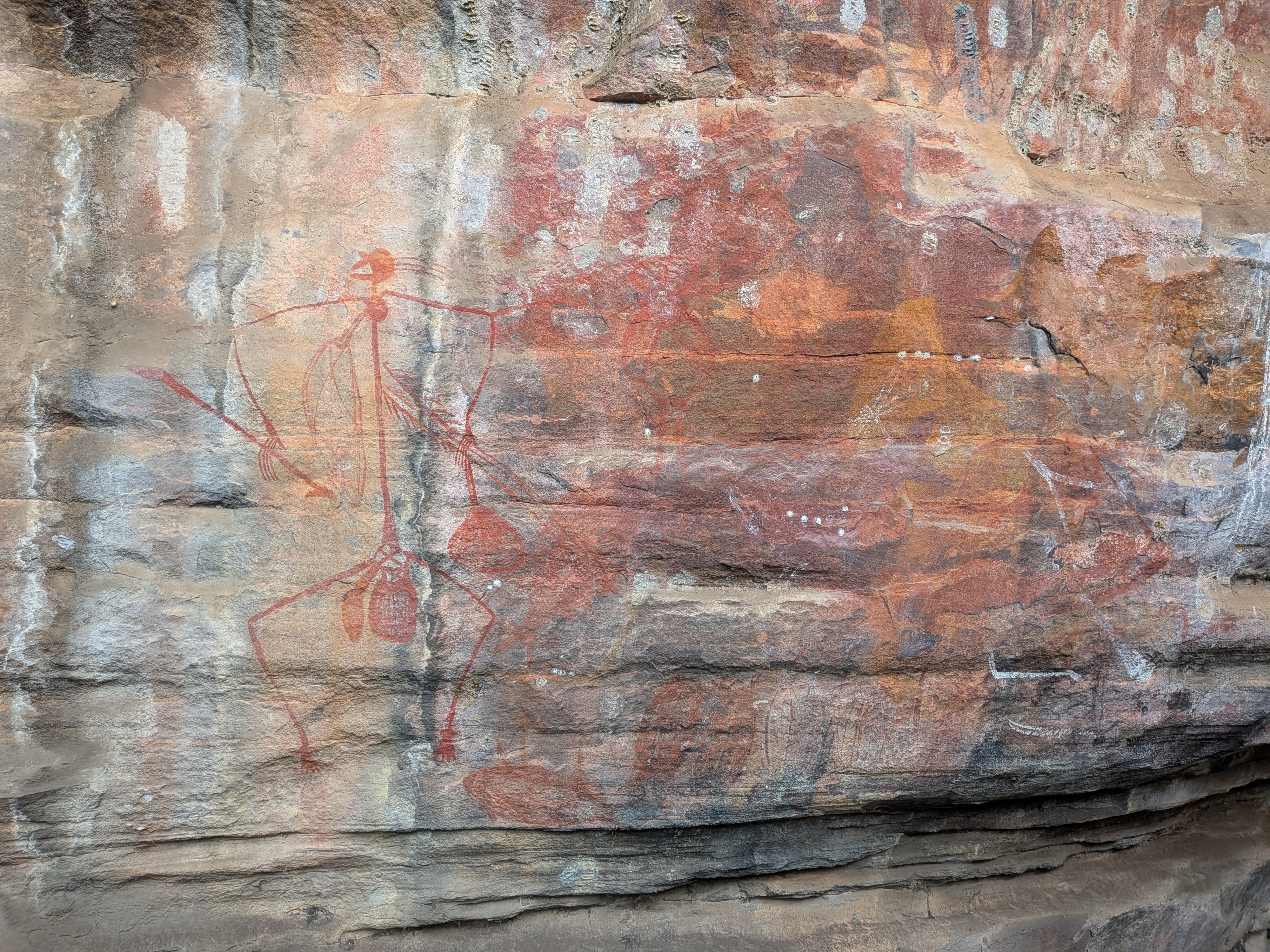 An ancient painting of a hunter with his spears on the walk up to Ubirr