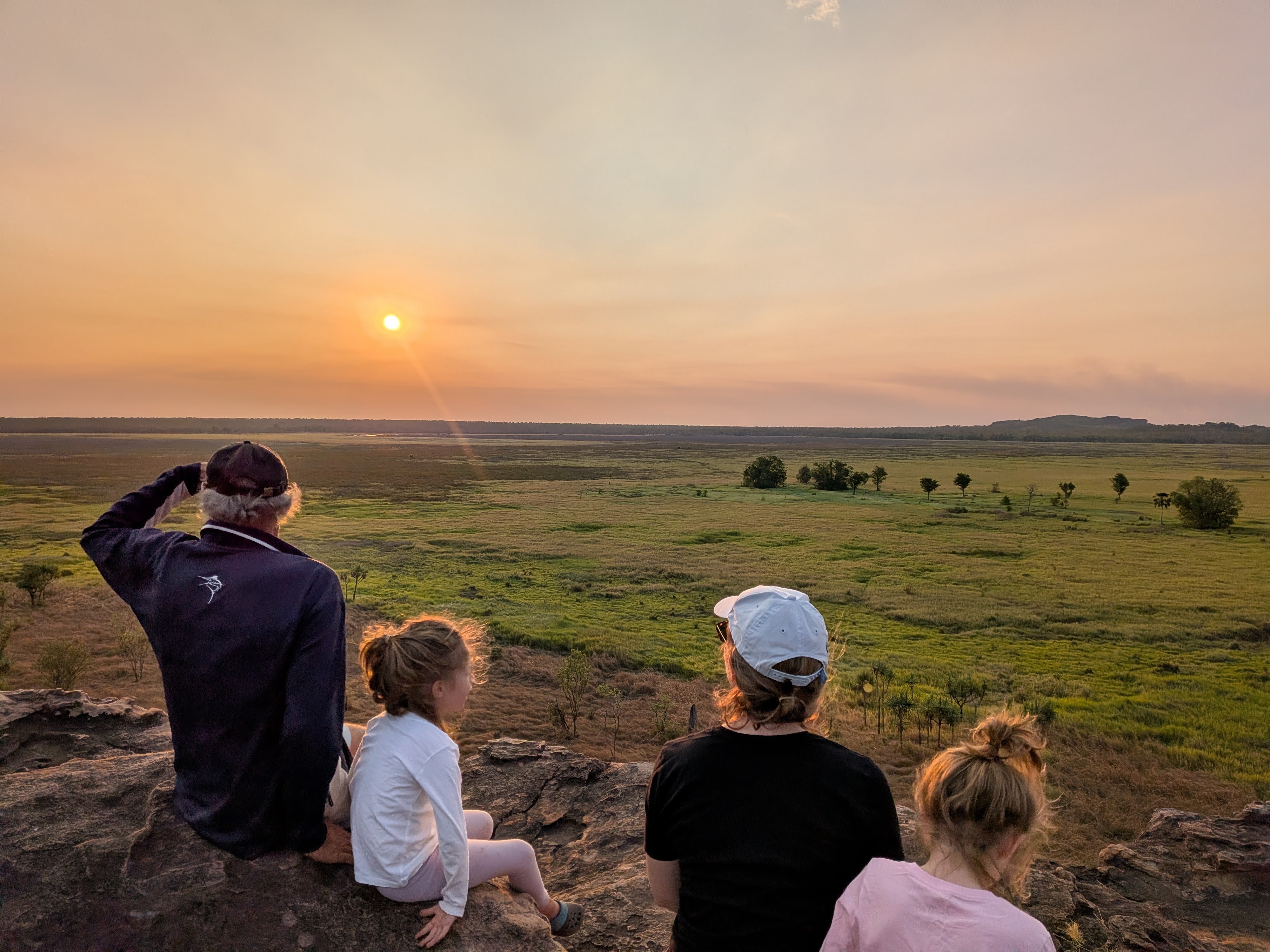 Pa, the girls and Erin watching the sunset from the rocks at Ubirr