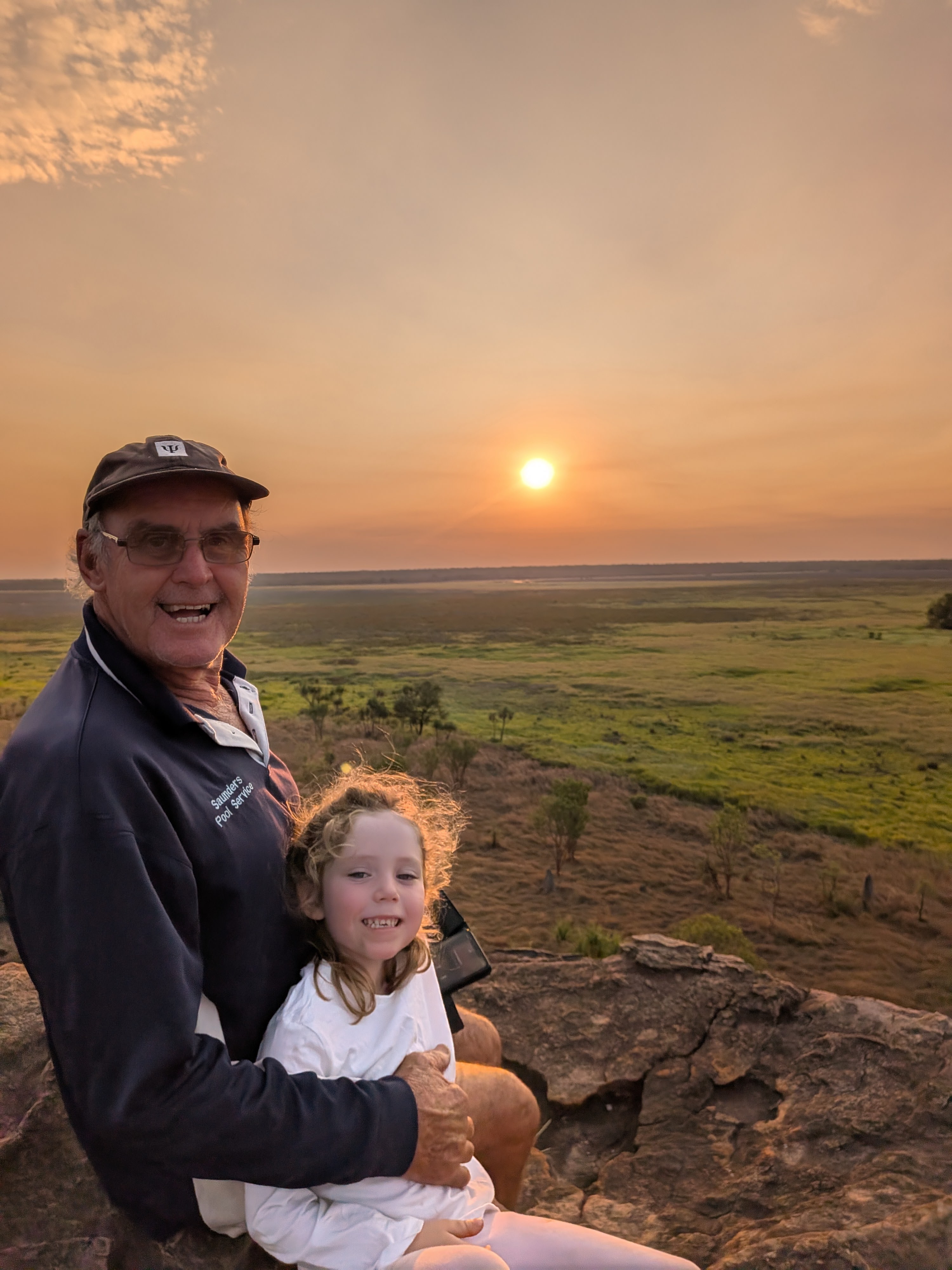 Pa with a lap passenger as the sun sinks over the floodplain