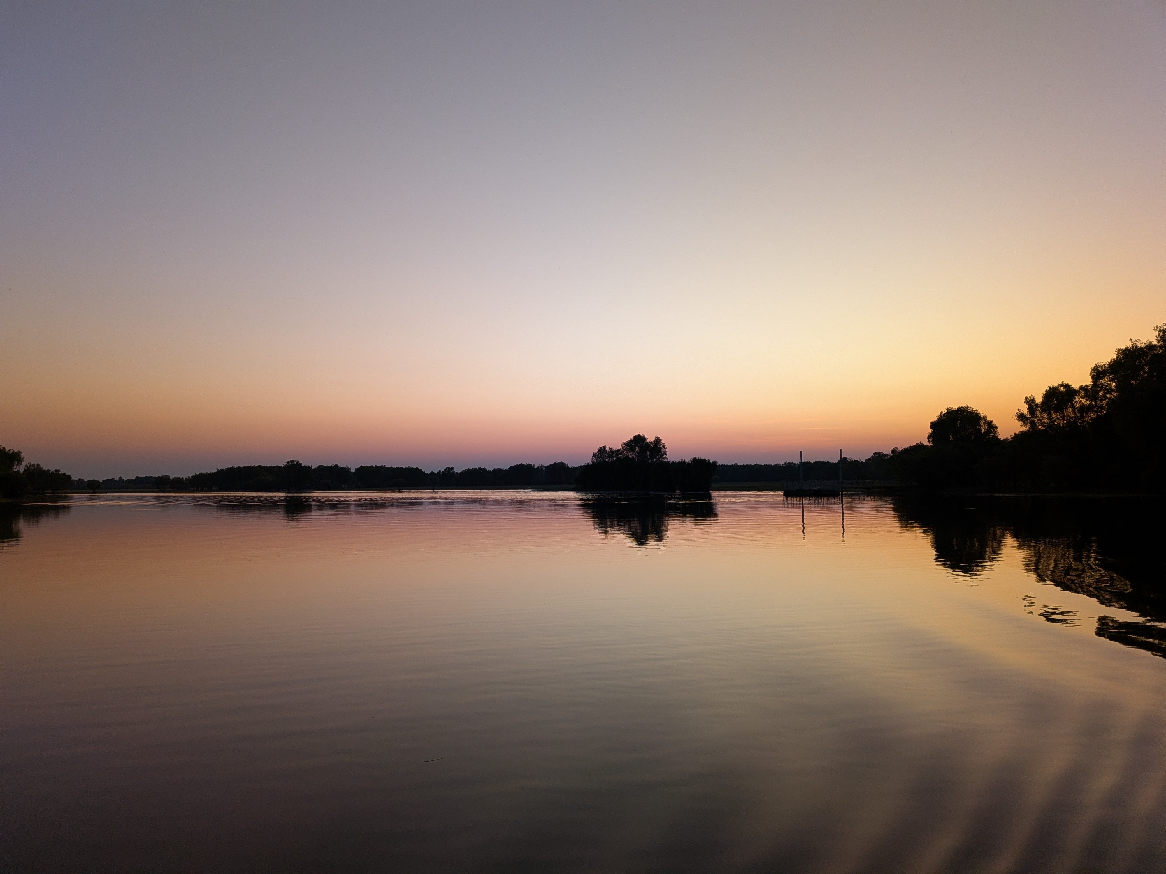 First light over Yellow Water billabong, mirror-still