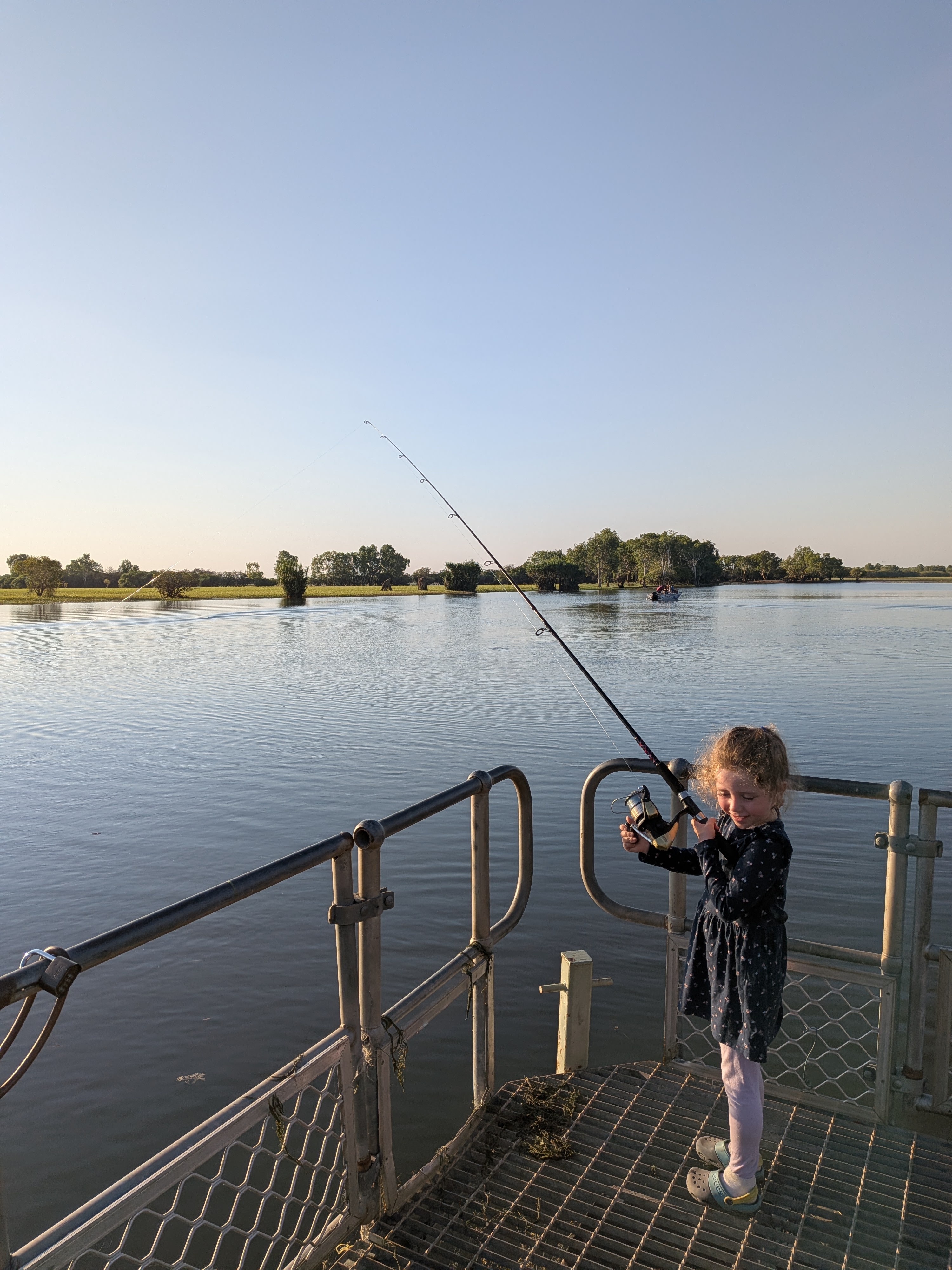 Leah trying her luck off the pontoon at golden hour &mdash; no luck whatsoever