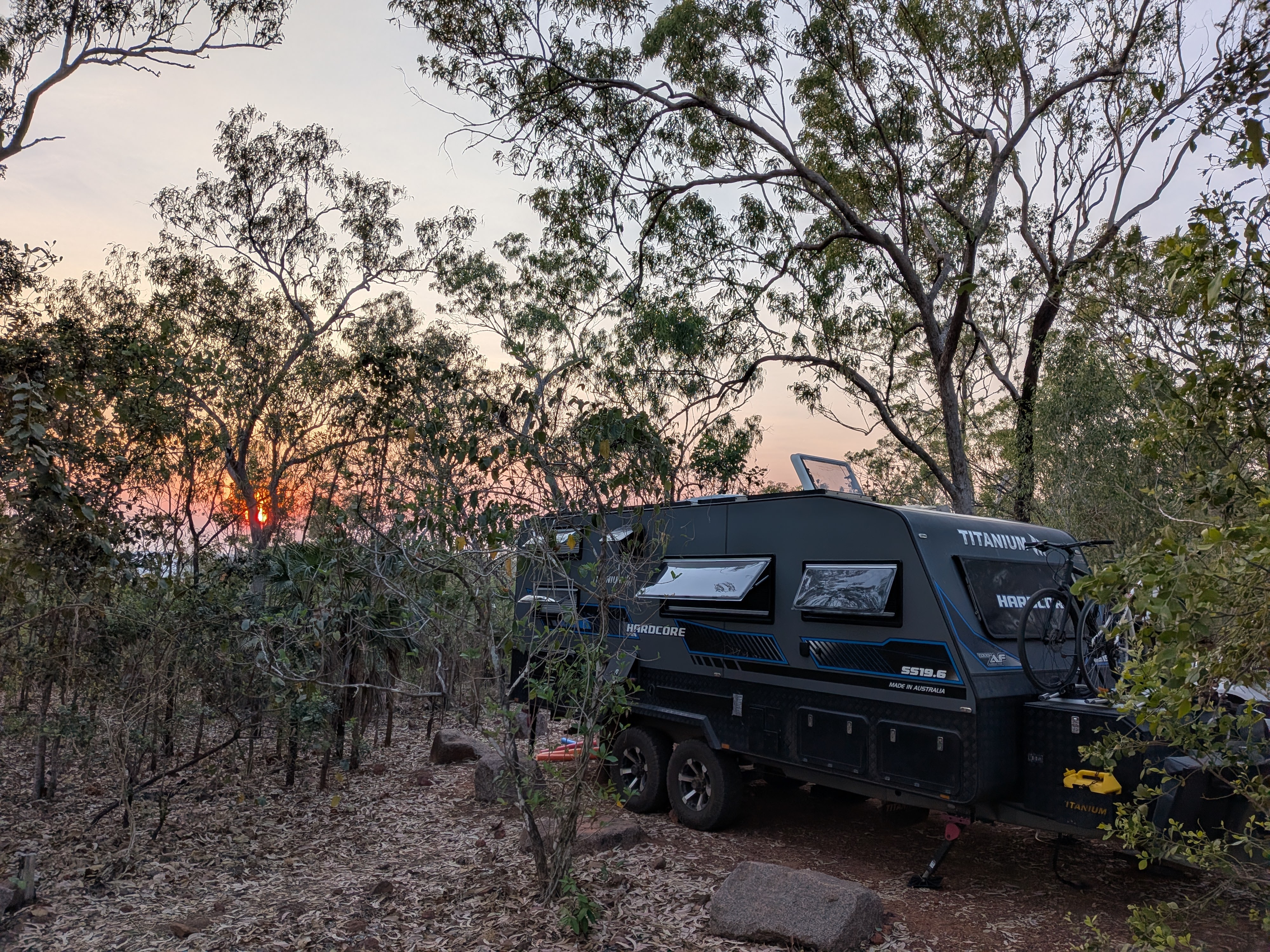 Sunrise through the trees behind TITANIUM HARDCORE at the elevated campsite