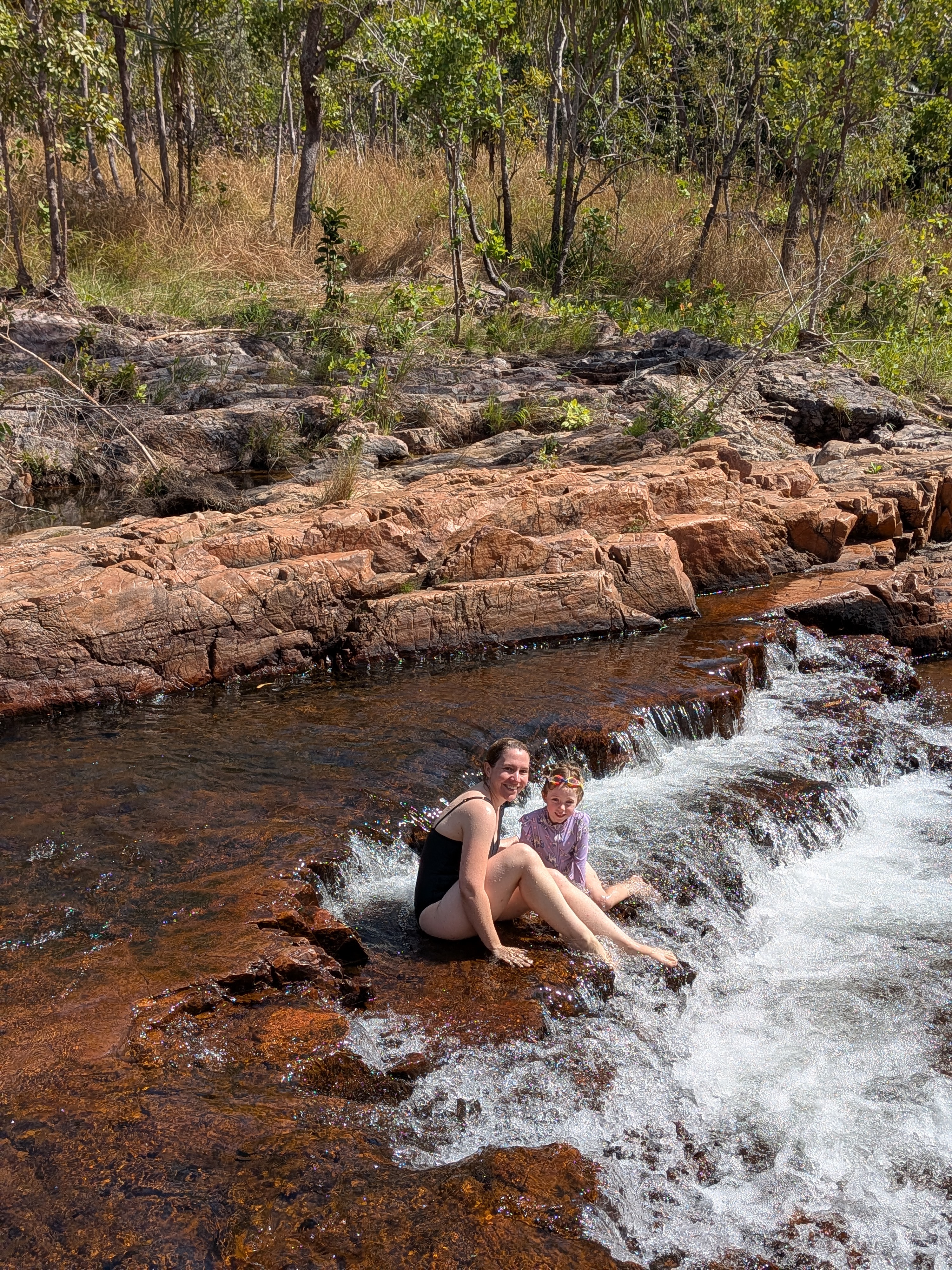 Erin and Leah sitting in the small falls at Buley