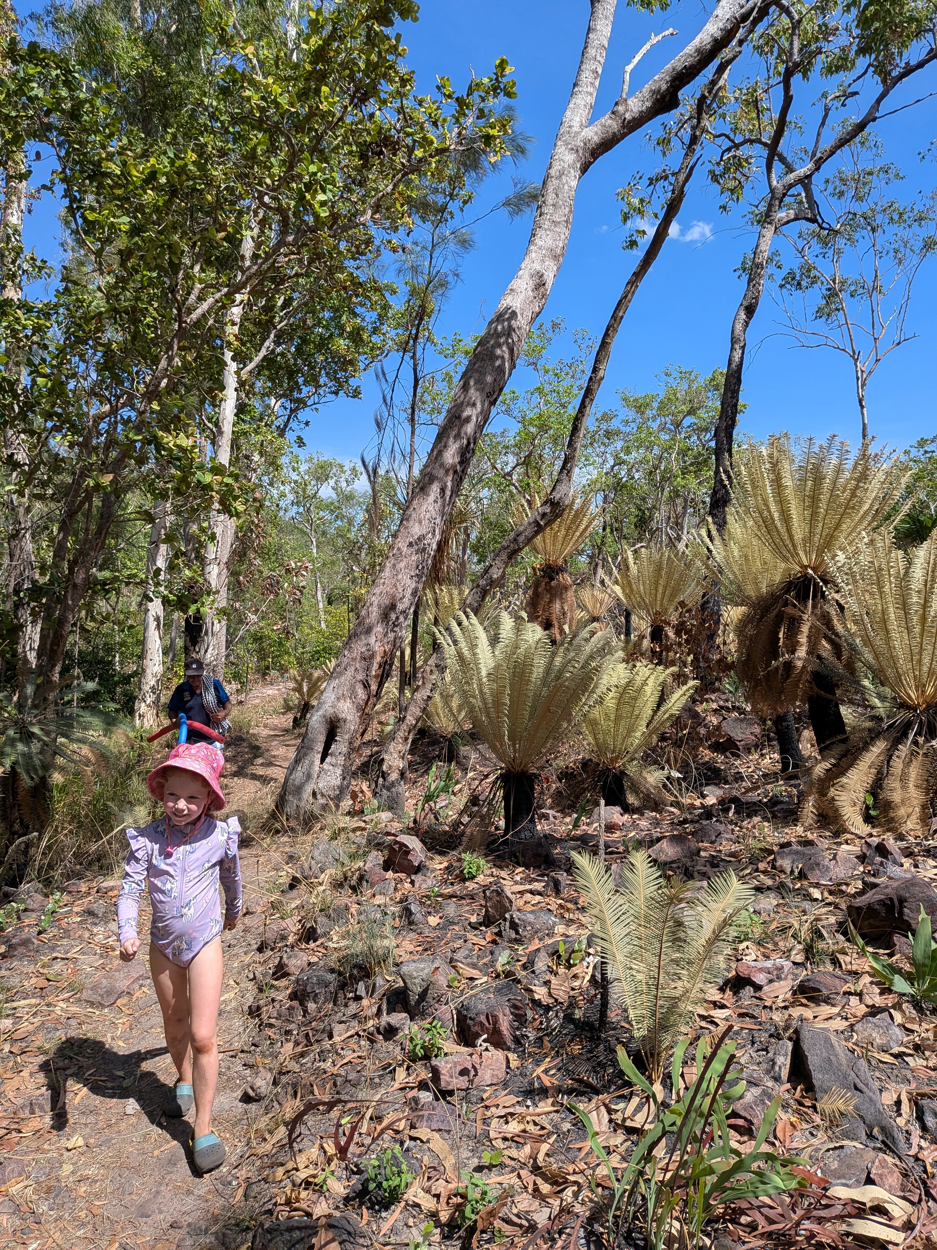 Leah and Pa walking through the forest of golden grass trees
