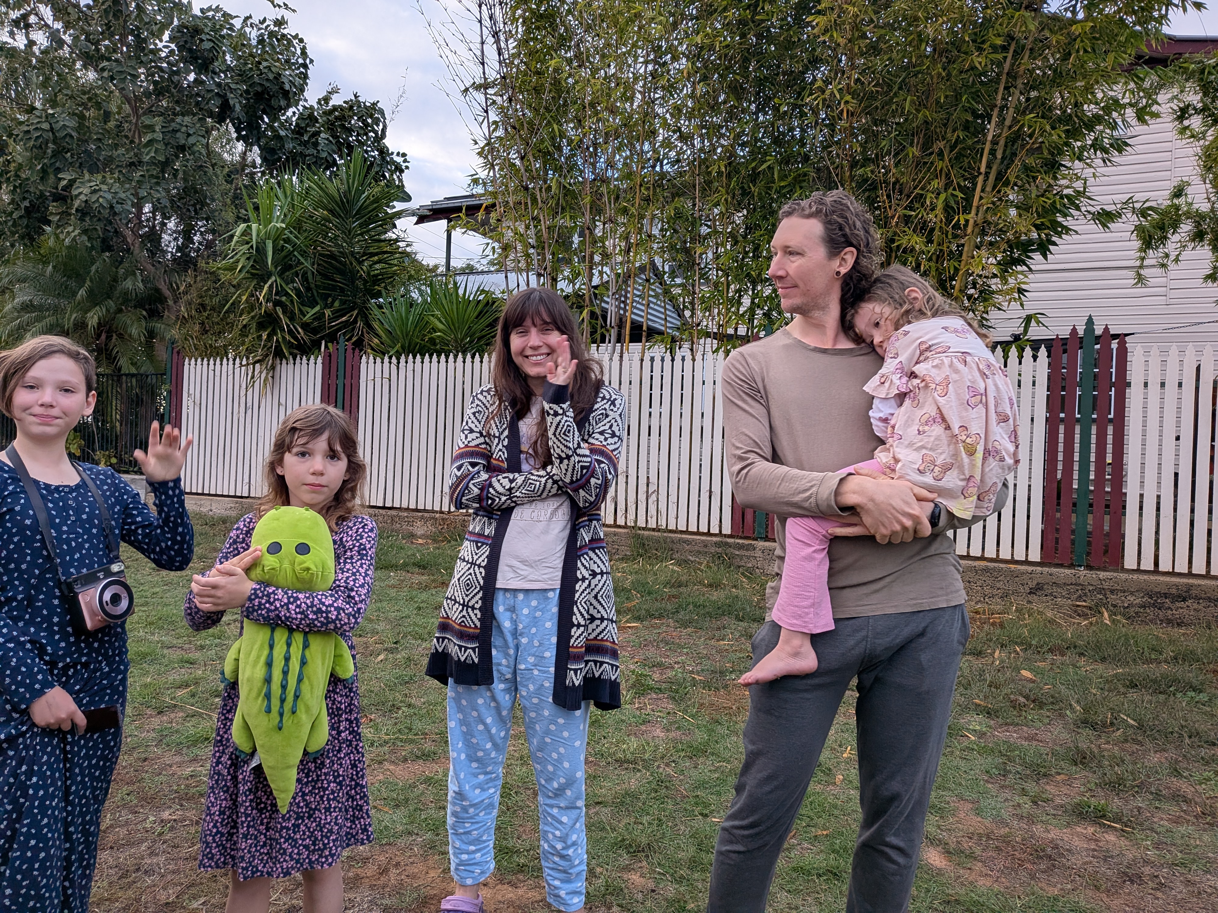 Saying goodbye to friends — Dylan holding Leah, kids with plushies