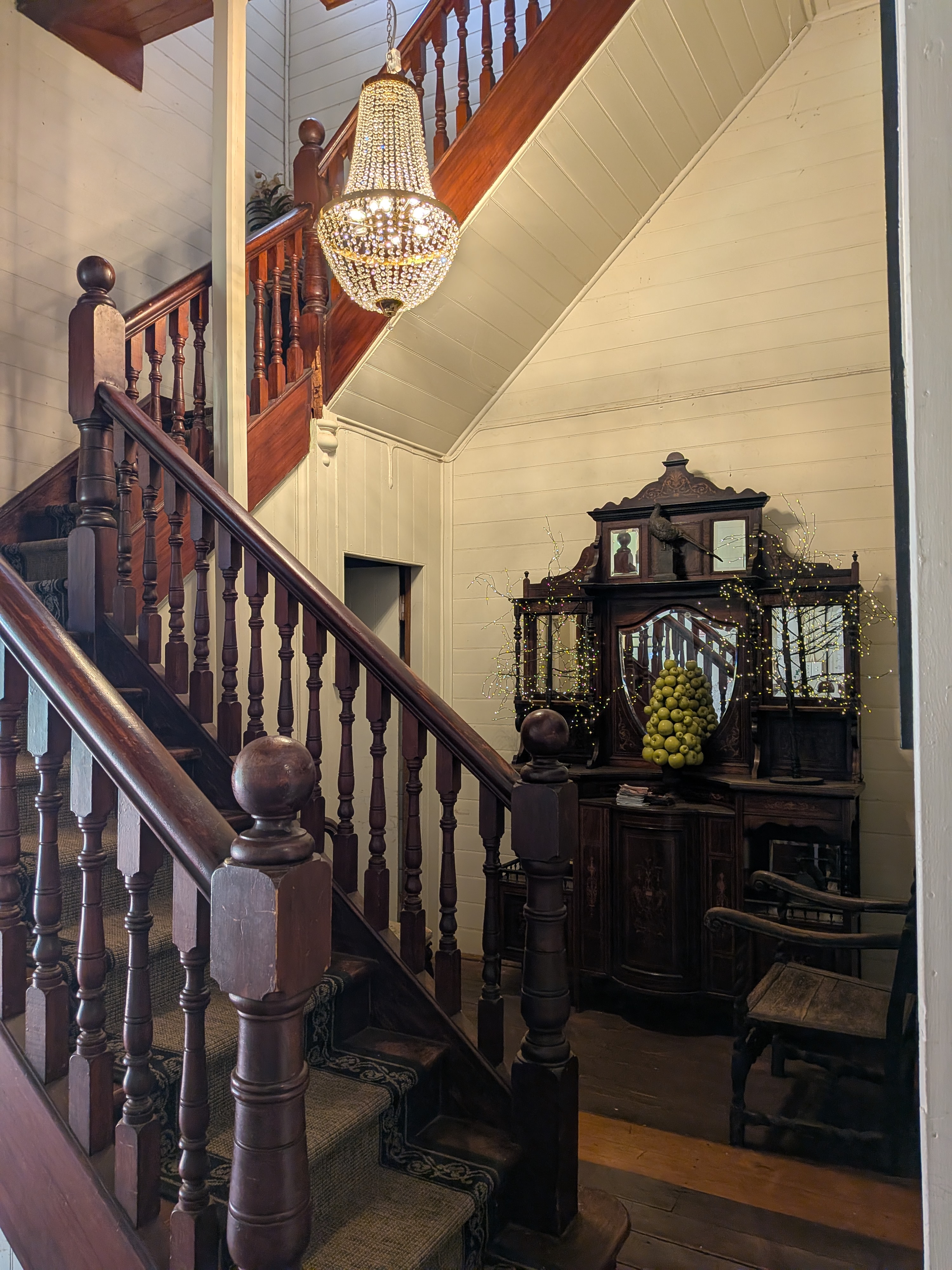 Inside The Lodge on Hawthorn — grand staircase and chandelier