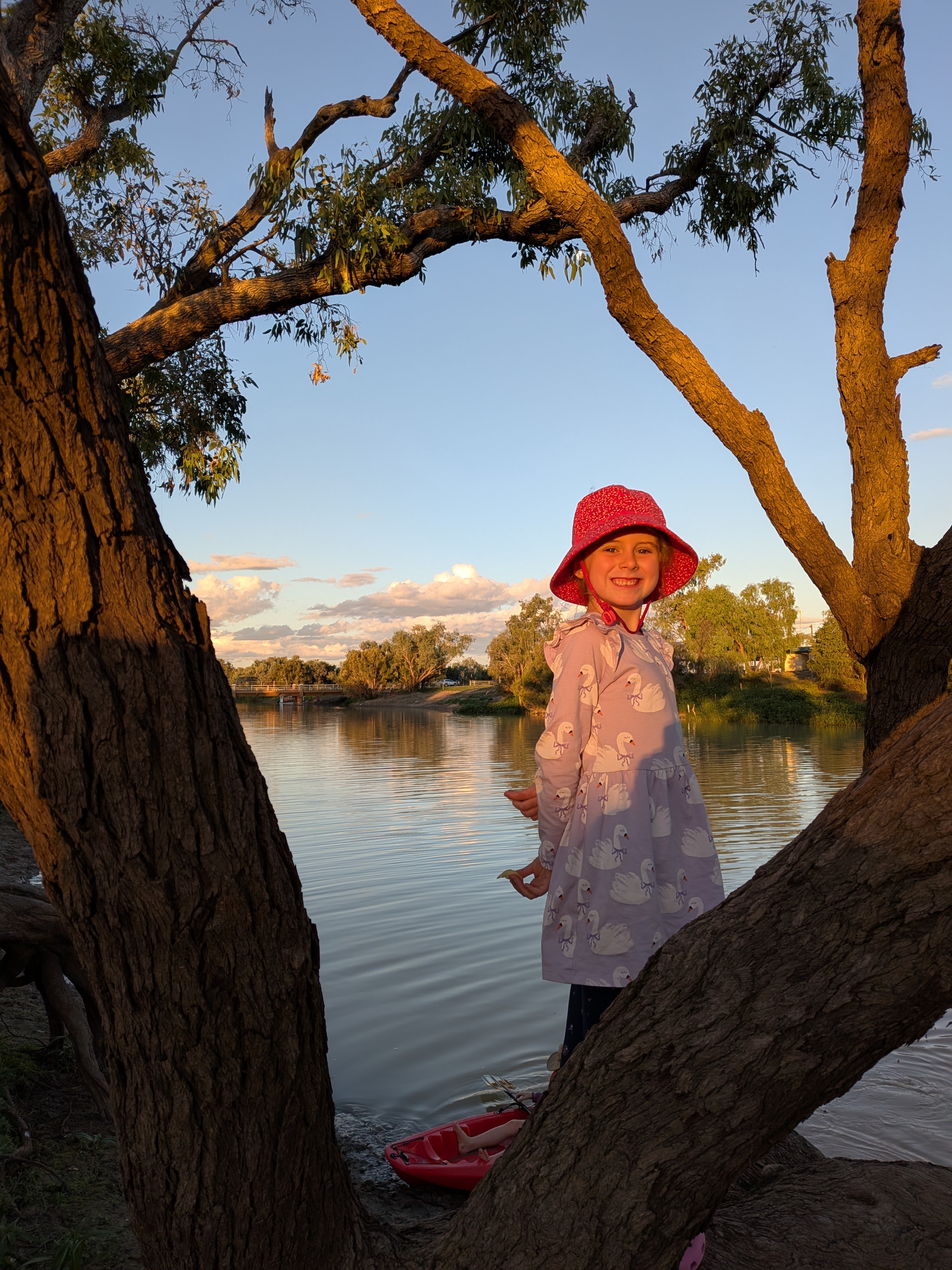 Leah framed by river gums at golden hour in Longreach
