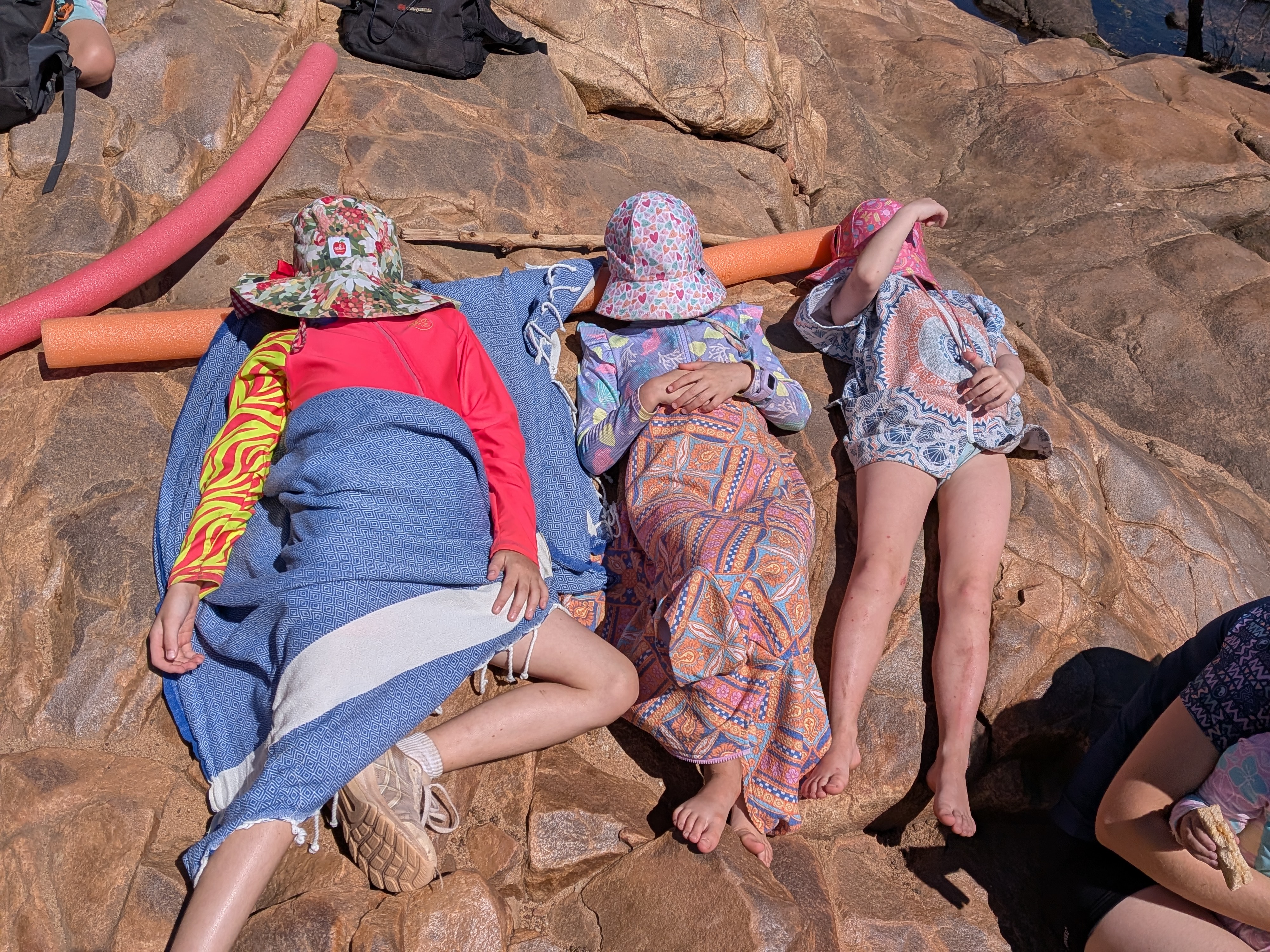 Post-swim recovery position &mdash; hats down, towels up, picnic pending