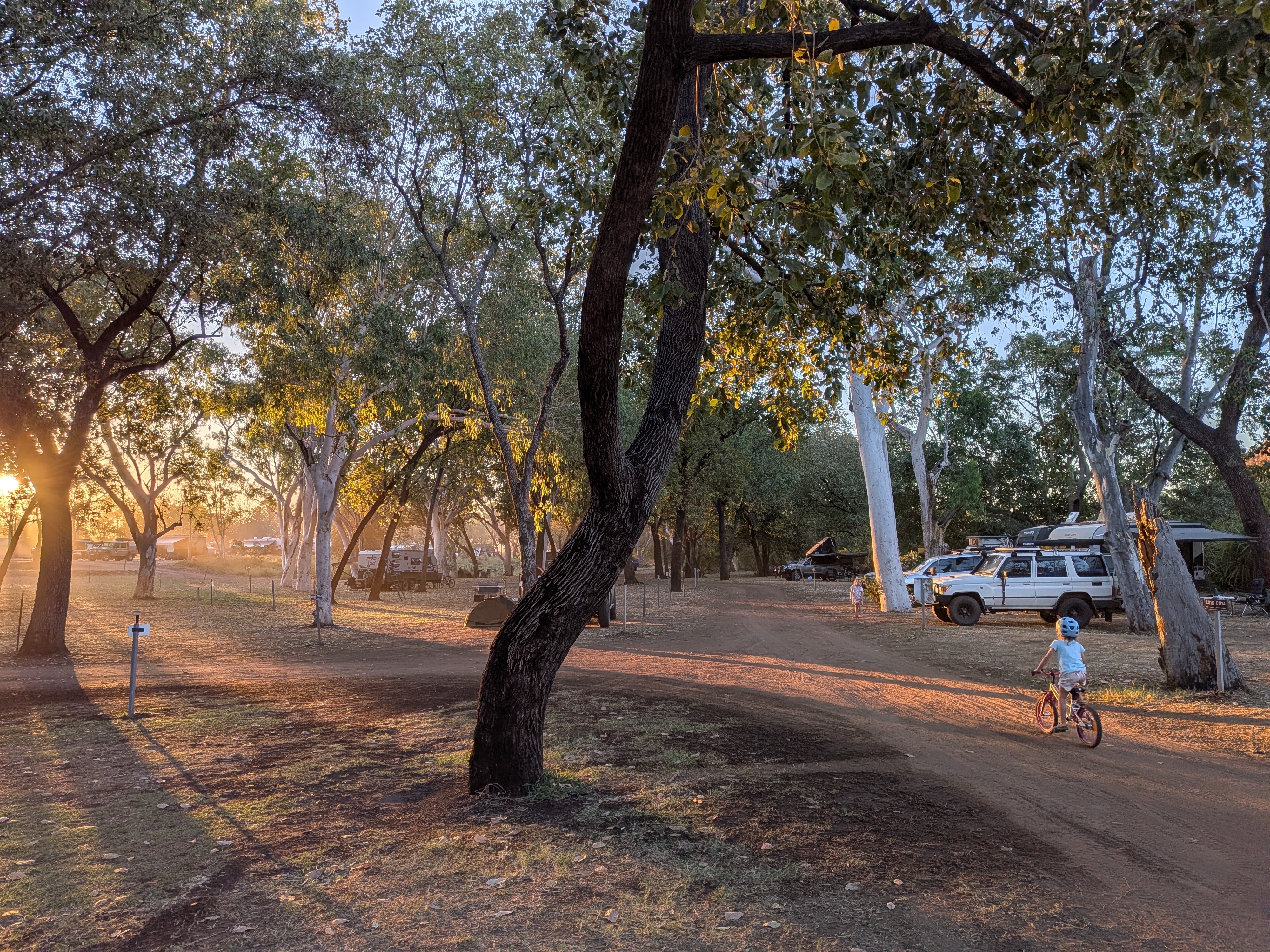 Golden hour at camp &mdash; bike laps on the red-dirt loop