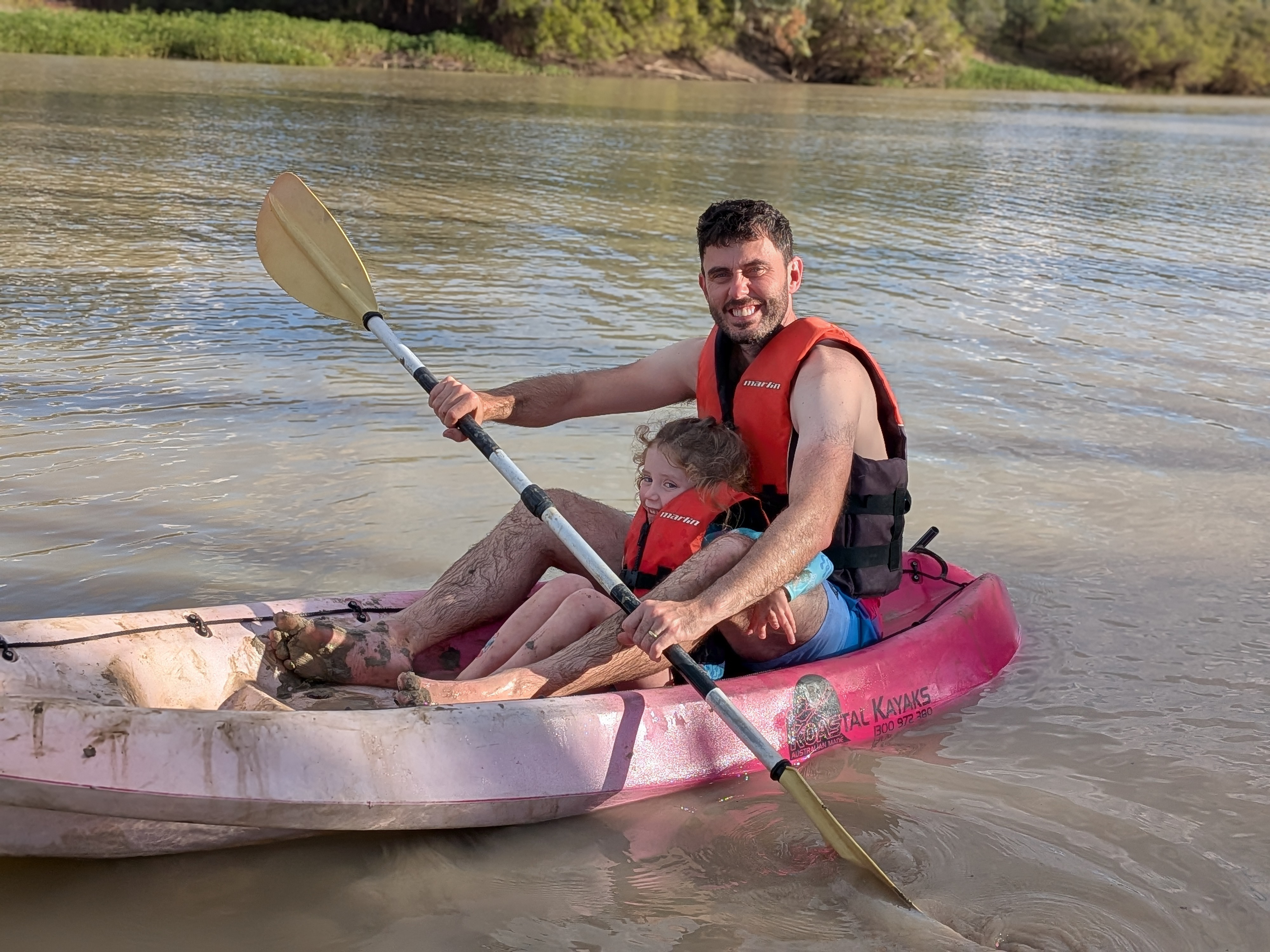 Dylan and Leah in a pink kayak on the river