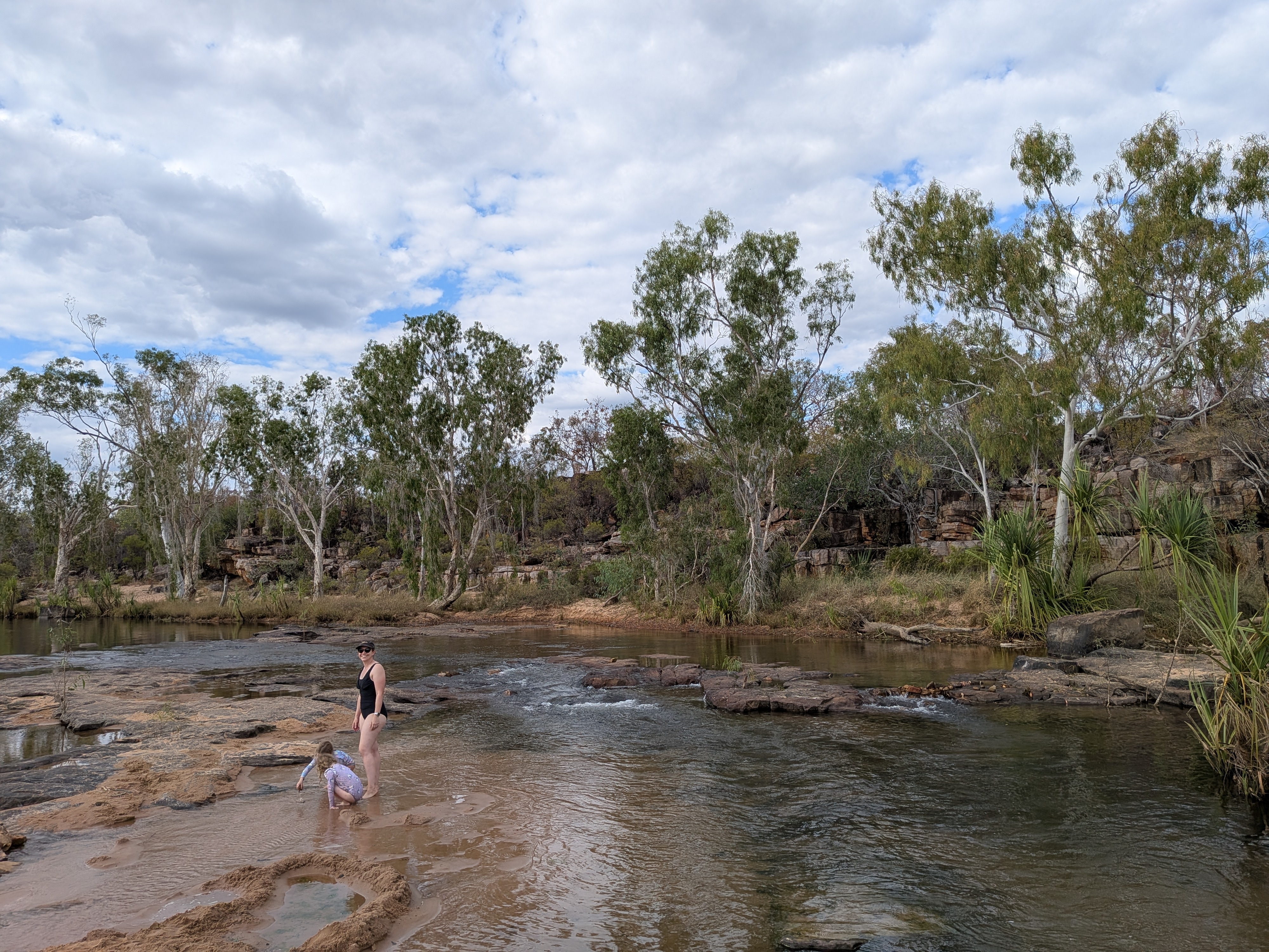 Erin and Leah wading beneath the rock face