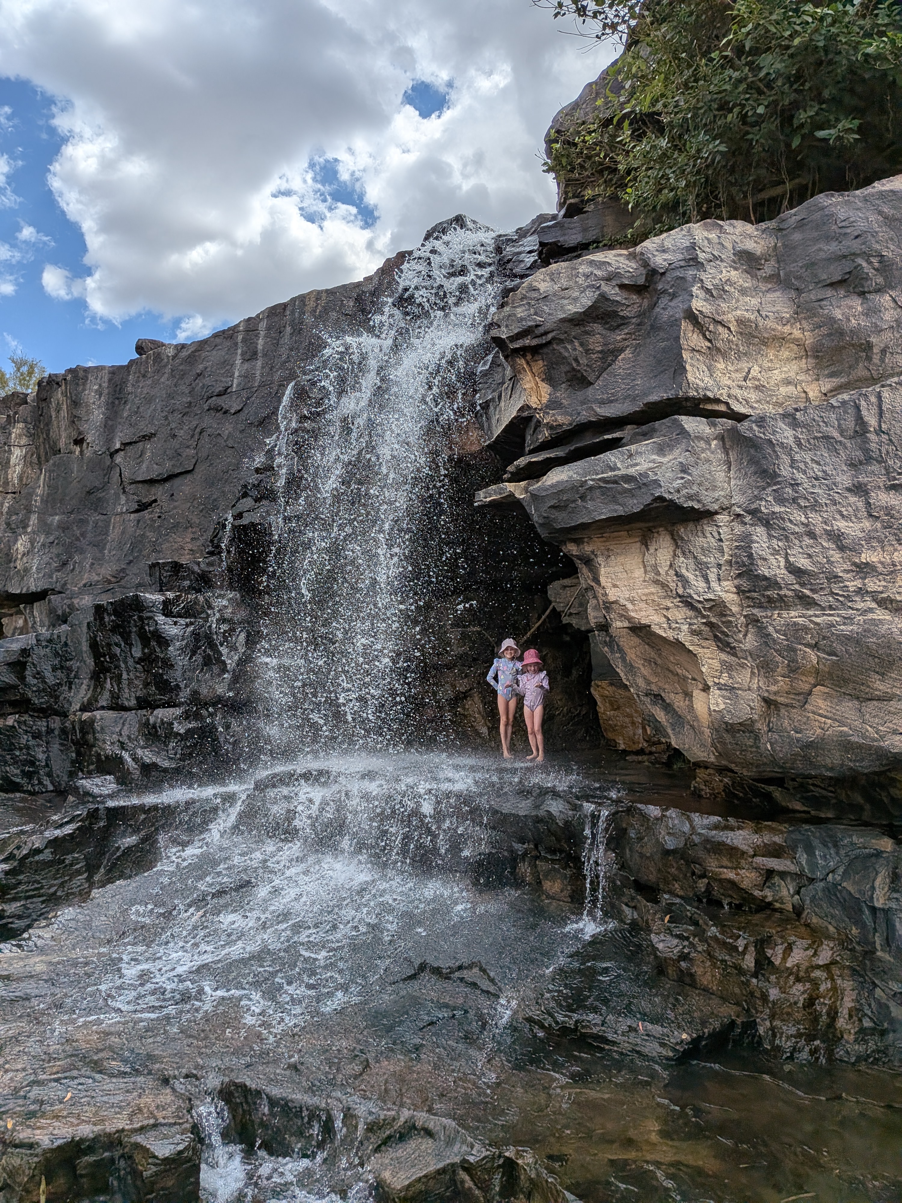 The girls showering under the waterfall at Wunnumurra Gorge