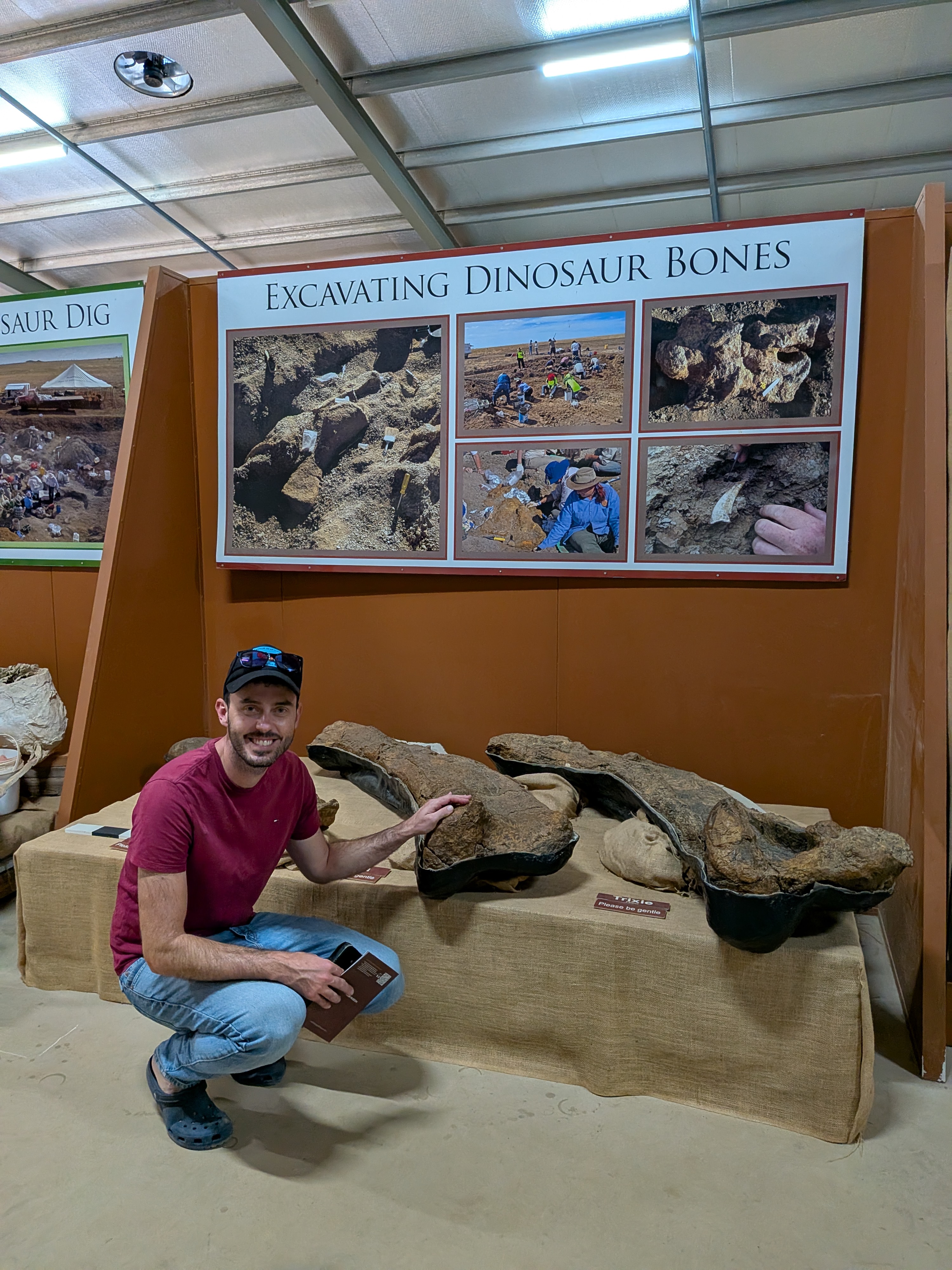 Dylan posing with excavated dinosaur bones at the museum
