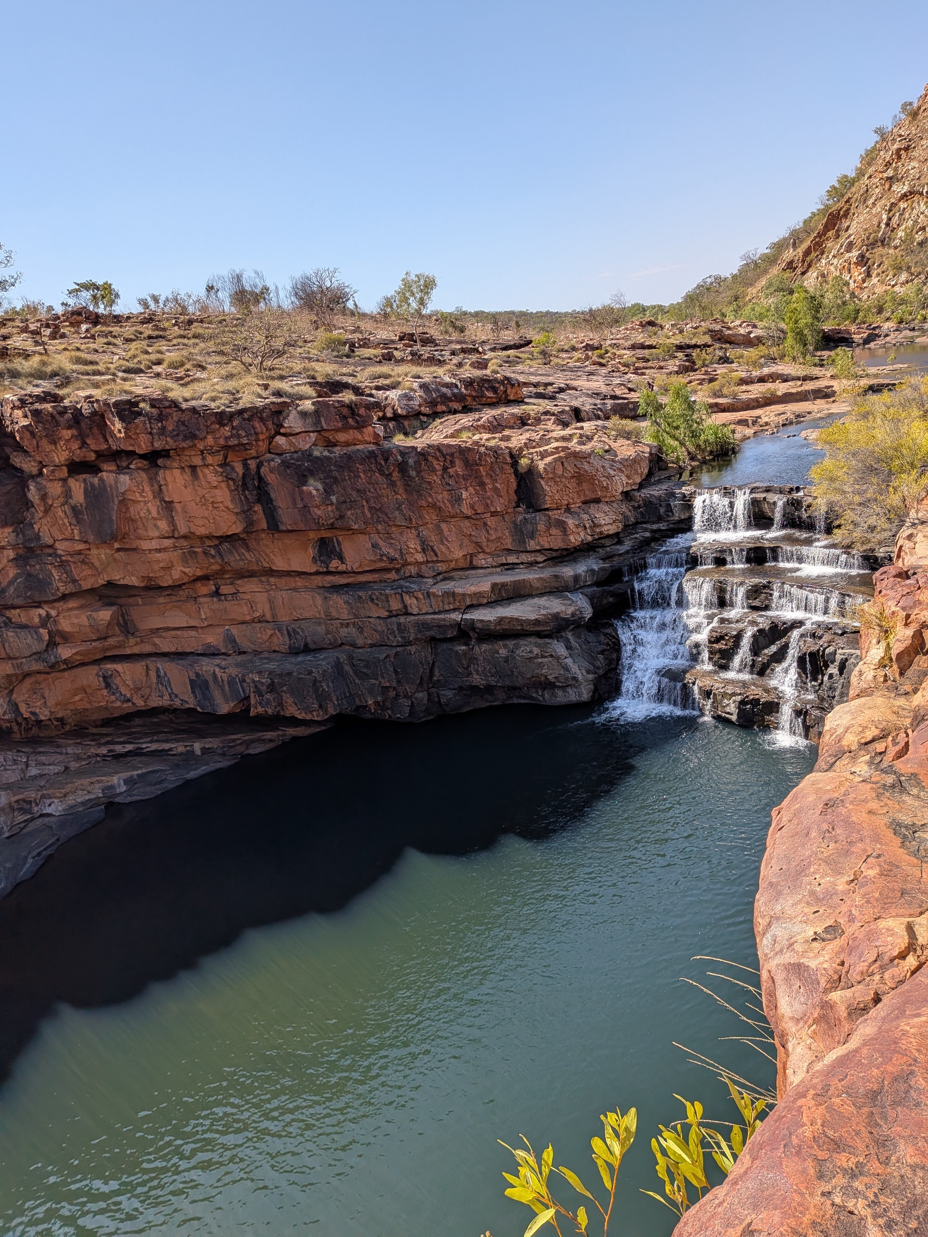 The falls pouring into the dark pool at the bottom