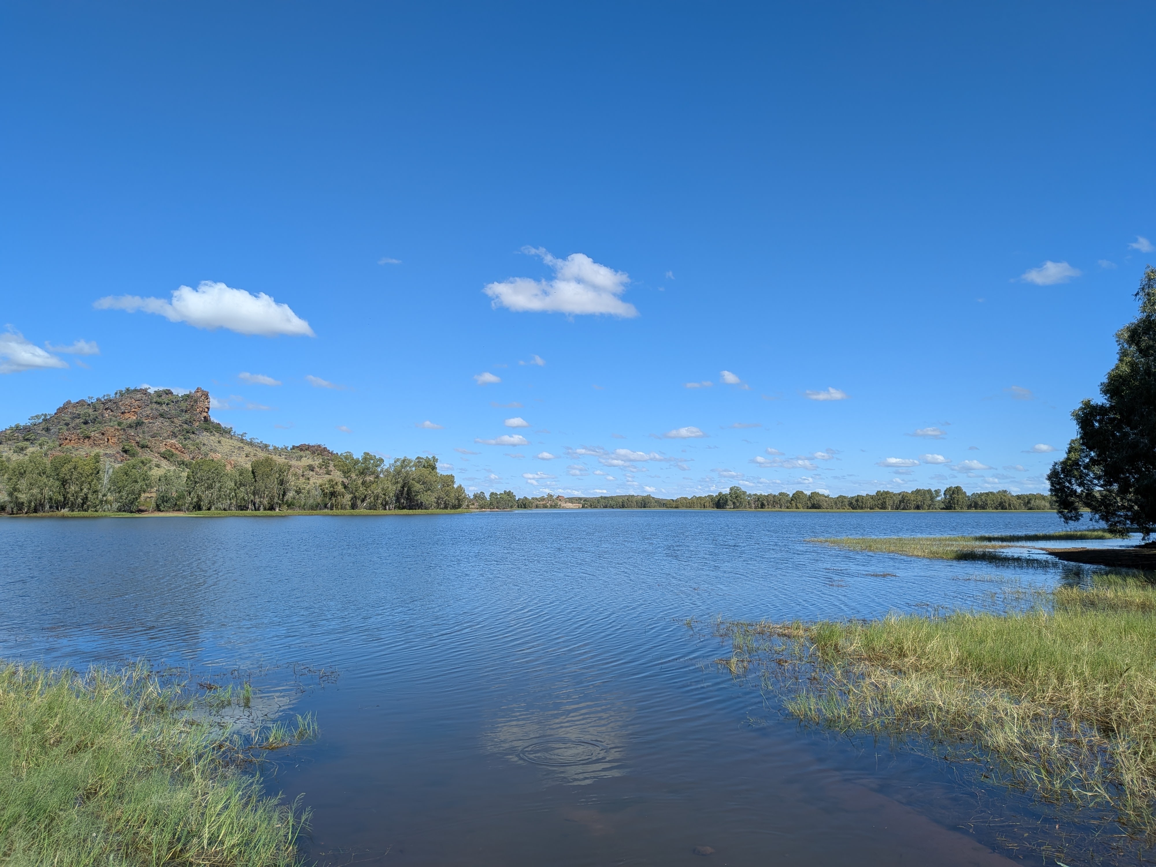 Chinaman Park dam at Cloncurry with rocky ridge and blue sky
