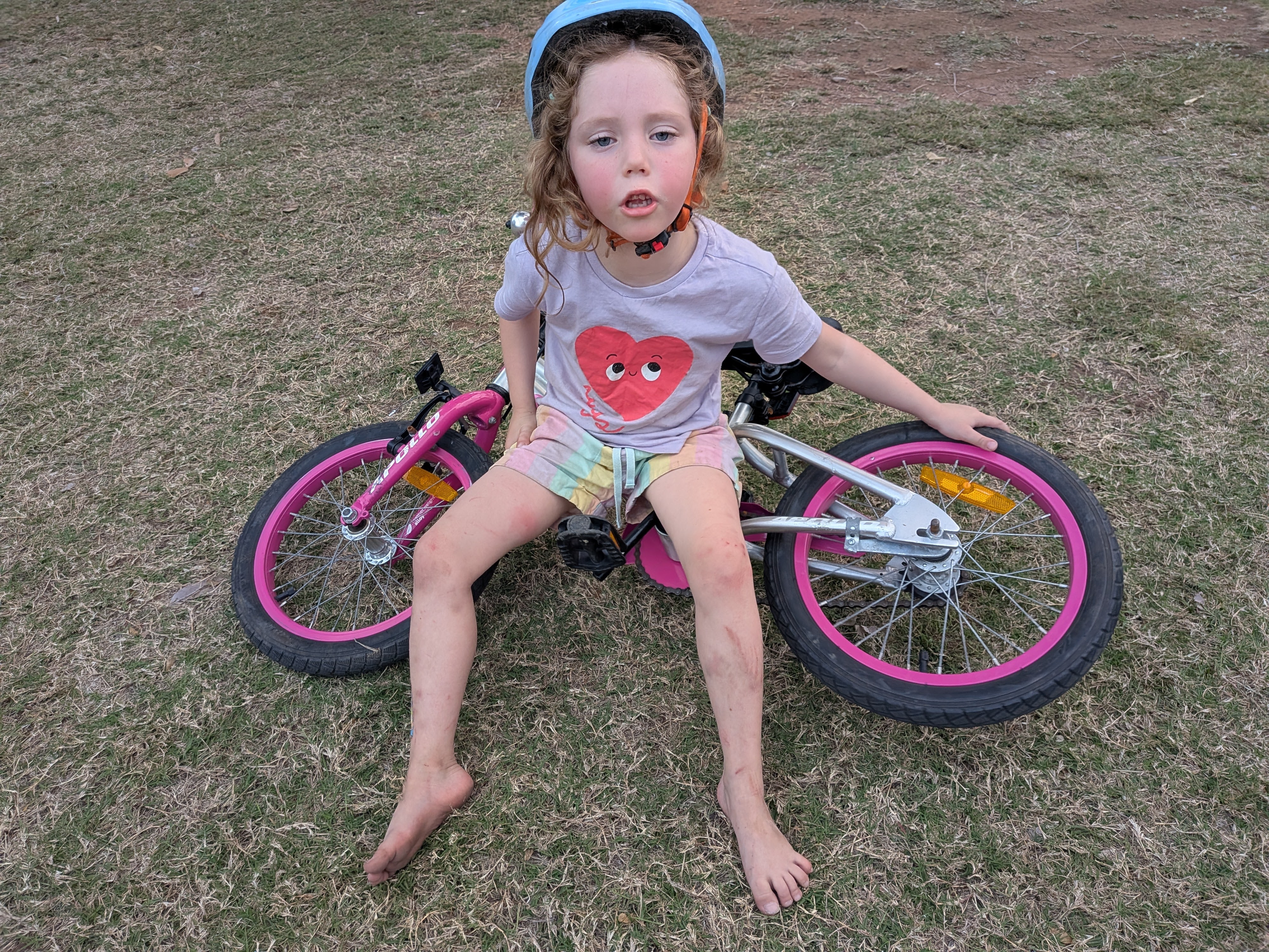Leah sitting on her bike after a tumble at the caravan park